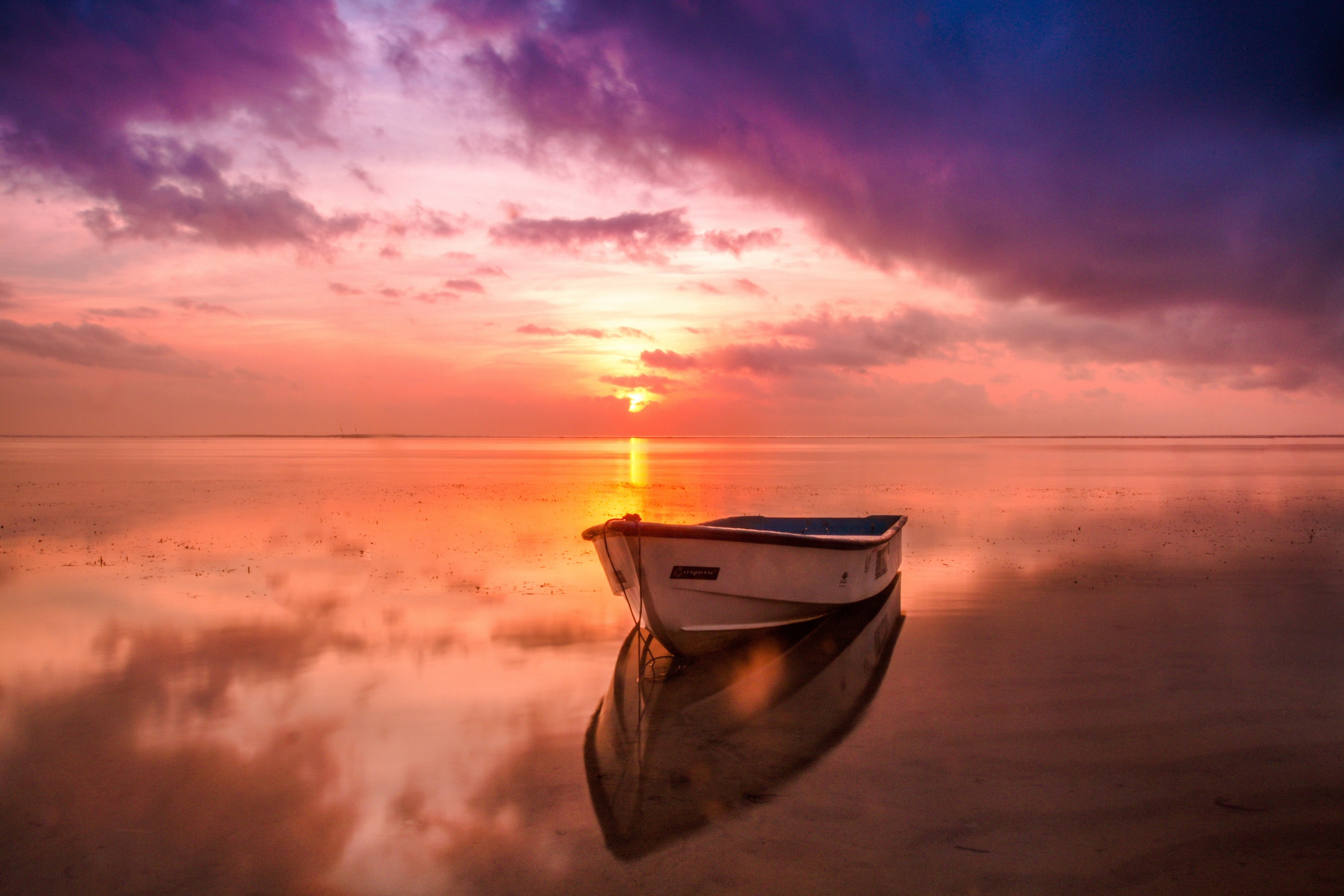 Serene Boat on Calm Water at 4K Sunset HD Wallpaper