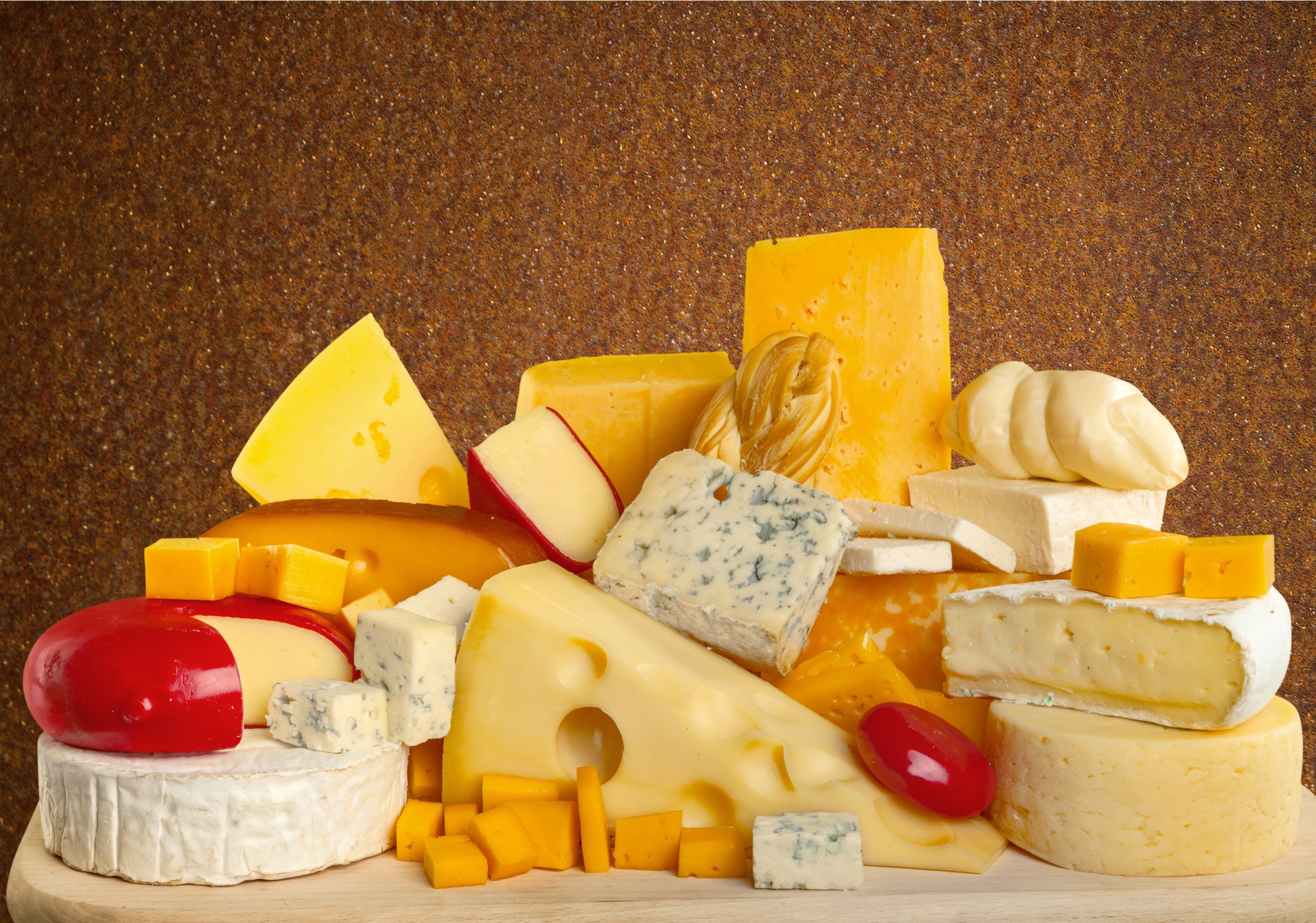 Assortment of cheeses on a textured background HD Wallpaper