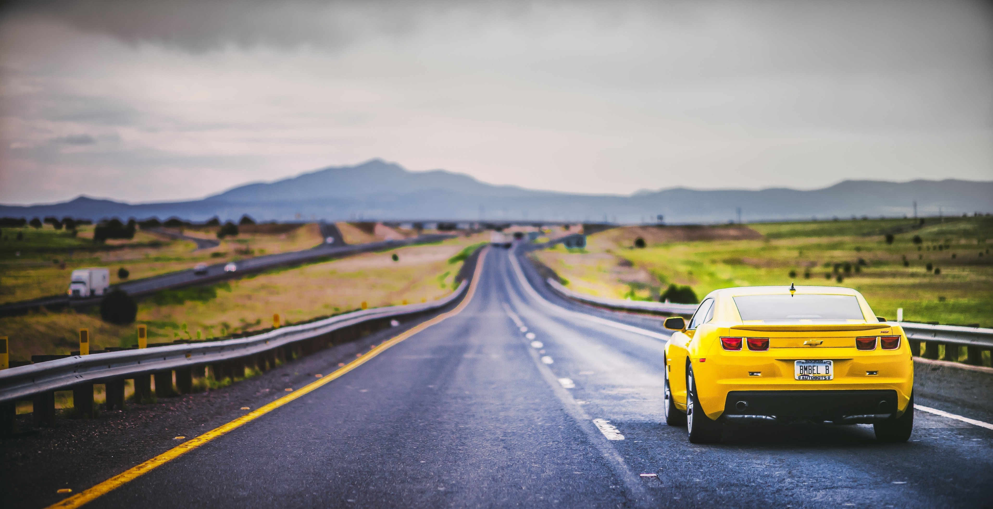 Yellow Chevrolet Camaro on a highway HD Wallpaper