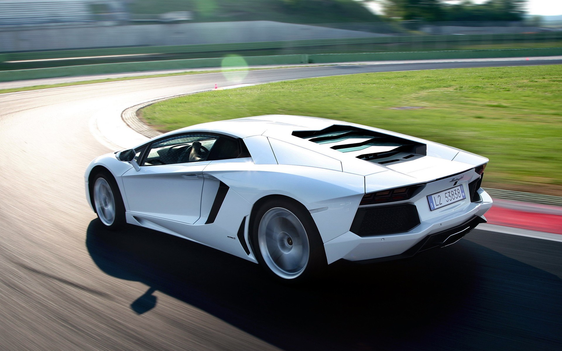 White Lamborghini Aventador driving on a race track HD Wallpaper