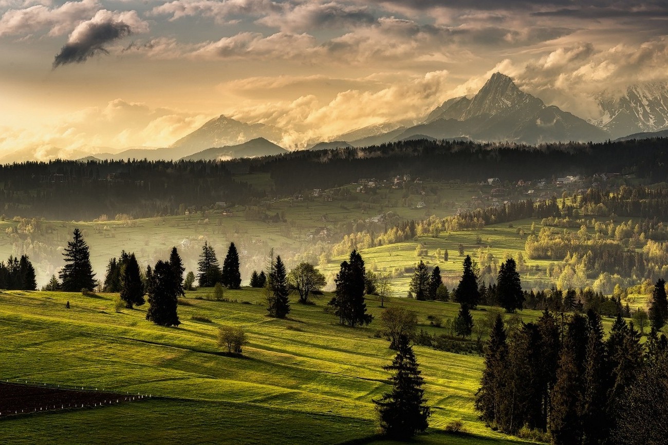Mountain landscape with forest and village at sunset HD Wallpaper