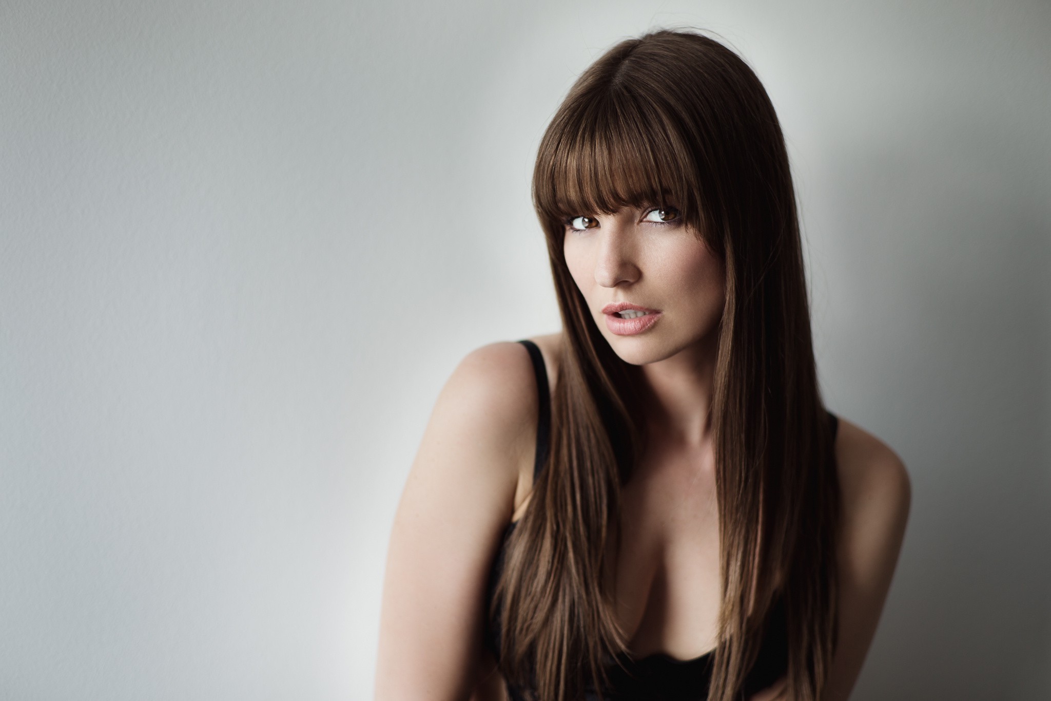 Woman with long brown hair and bangs HD Wallpaper