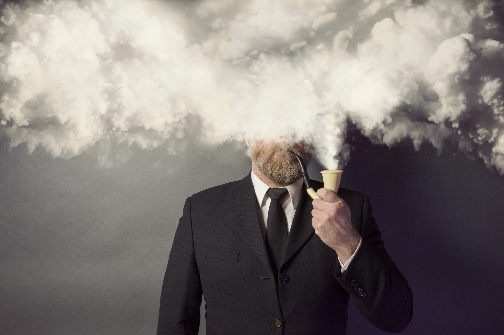 Man in suit smoking pipe with smoke obscuring face HD Wallpaper