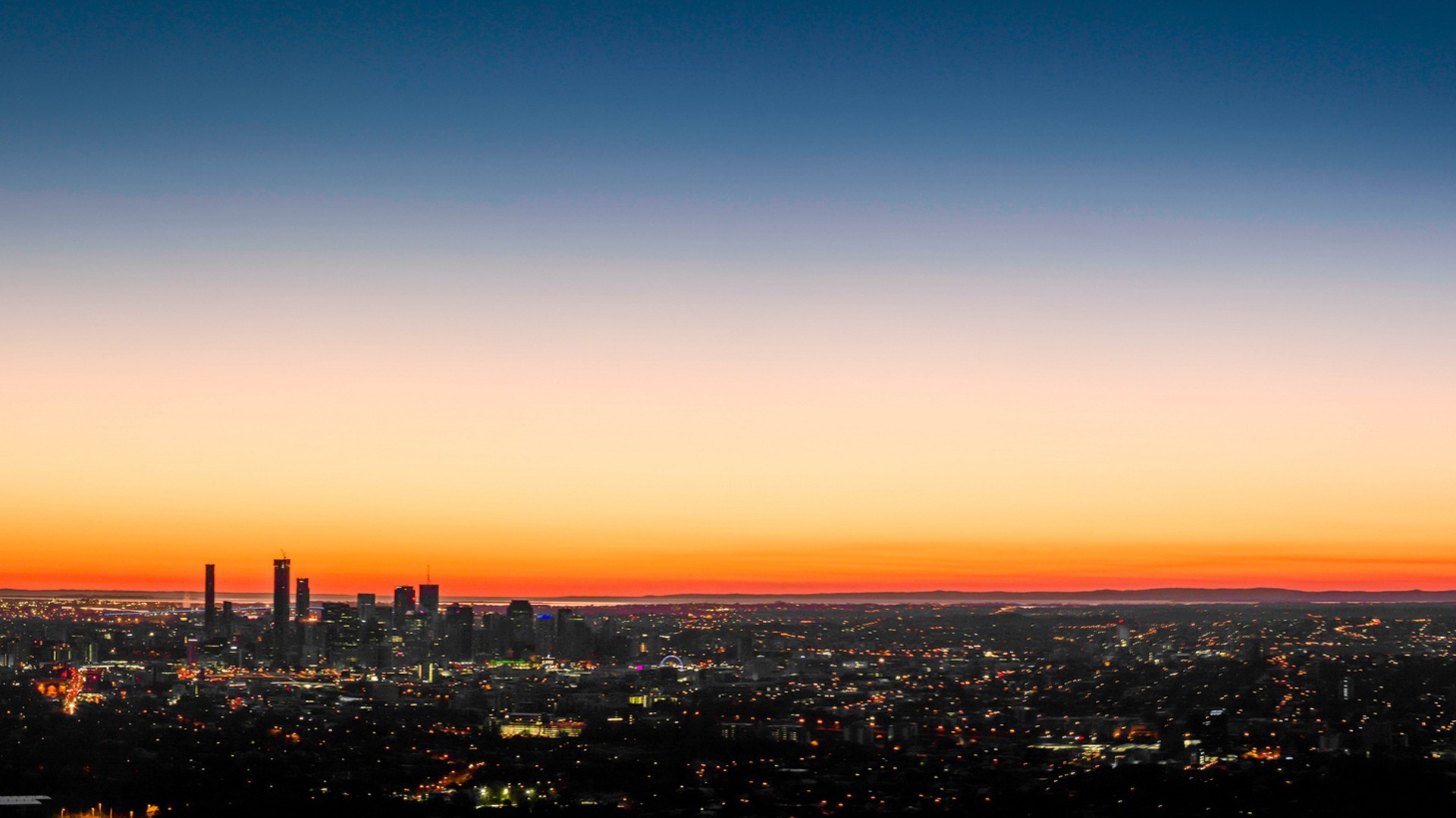 Cityscape at sunset with gradient sky HD Wallpaper
