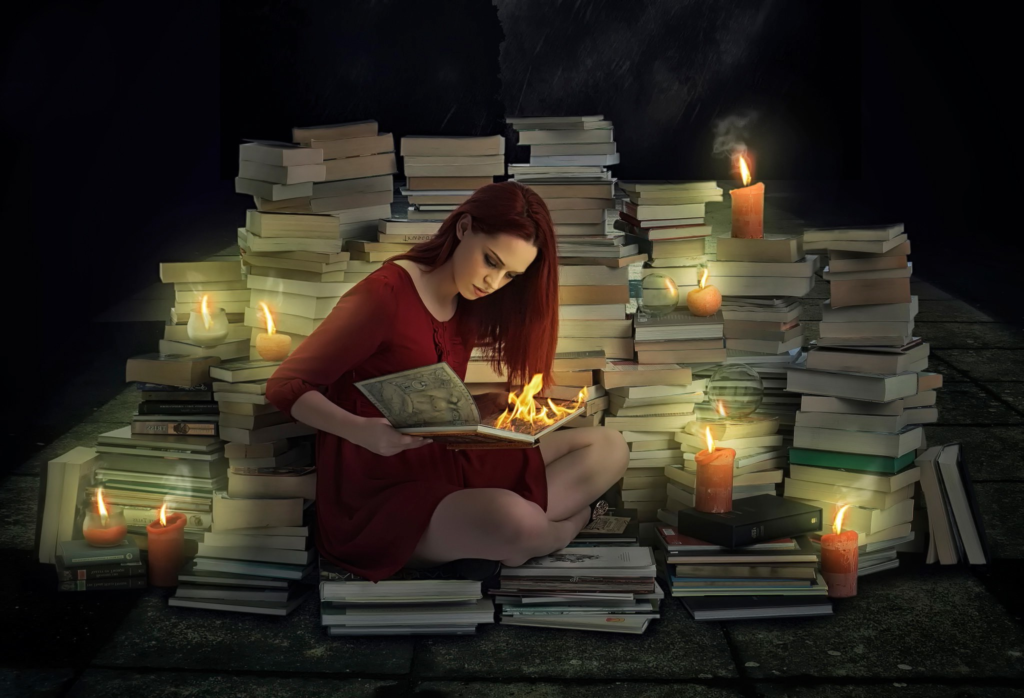 Woman reading a burning book surrounded by books and candles HD Wallpaper