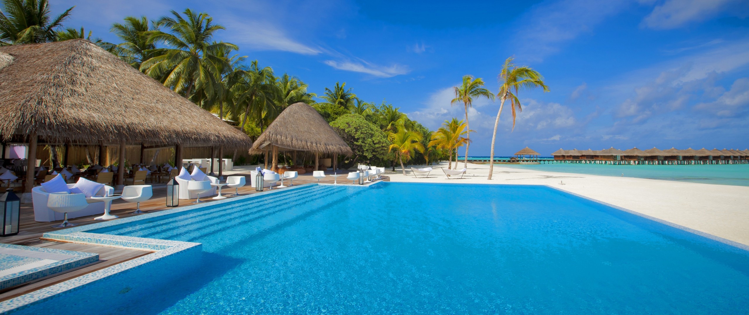 Resort swimming pool with overwater bungalows in the Maldives HD Wallpaper