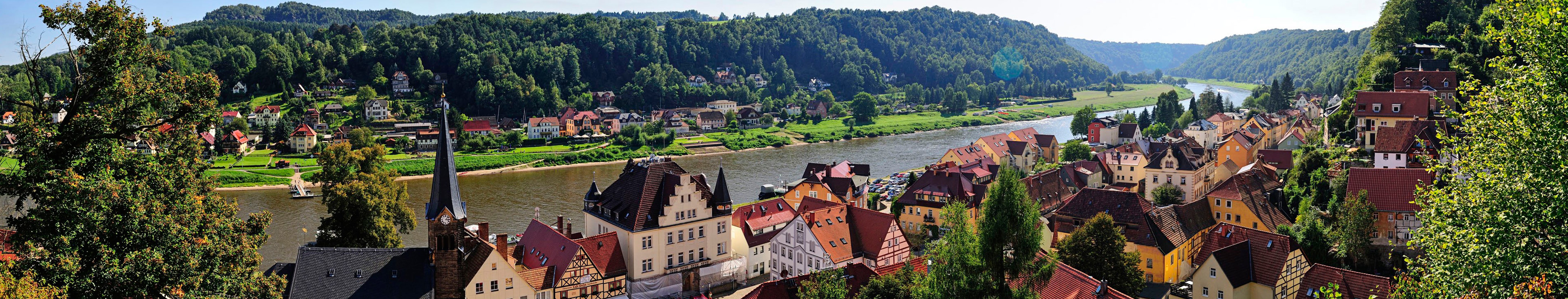 Picturesque German Town by River with Hills and Trees HD Wallpaper