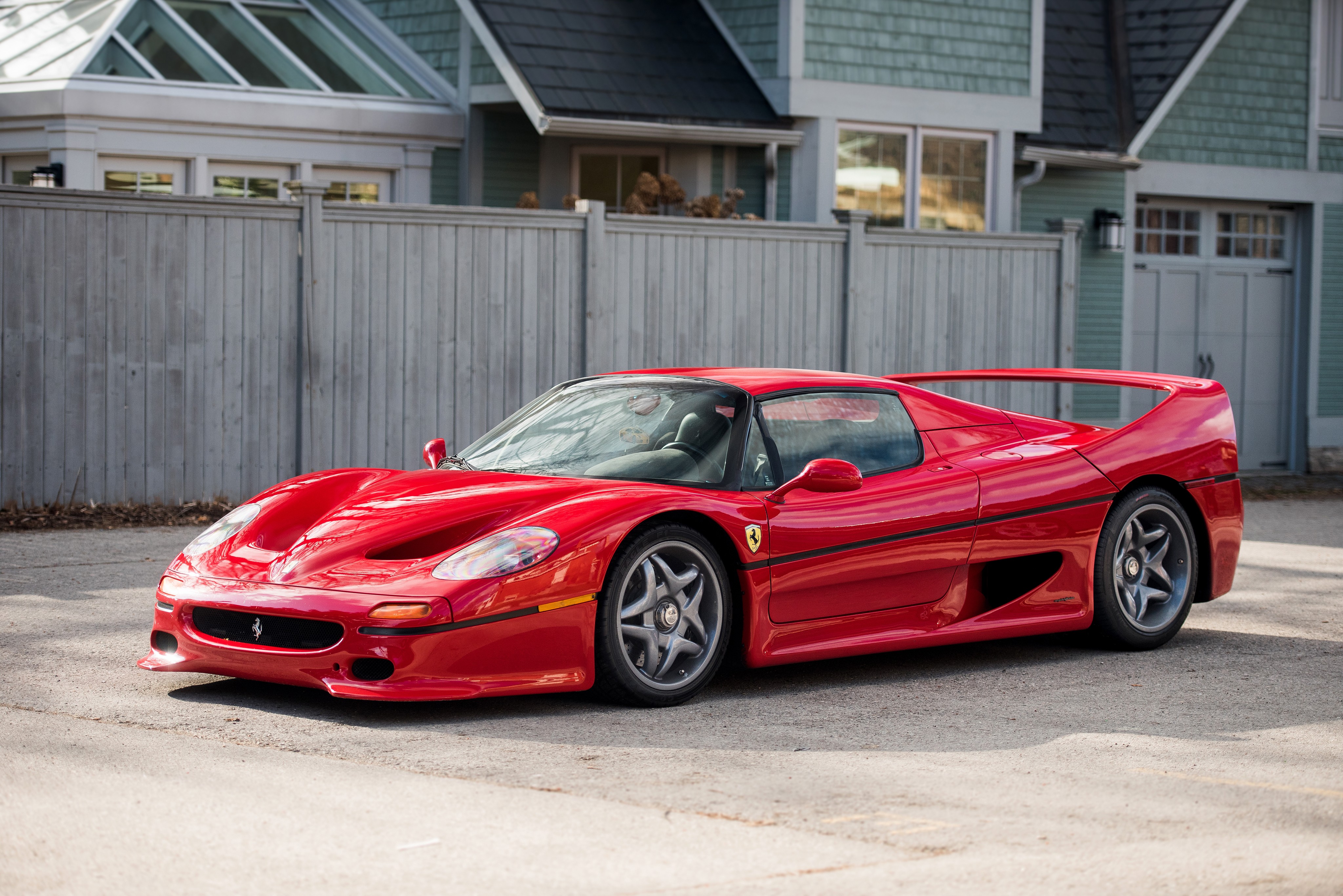Red Ferrari F50 parked in front of a house HD Wallpaper