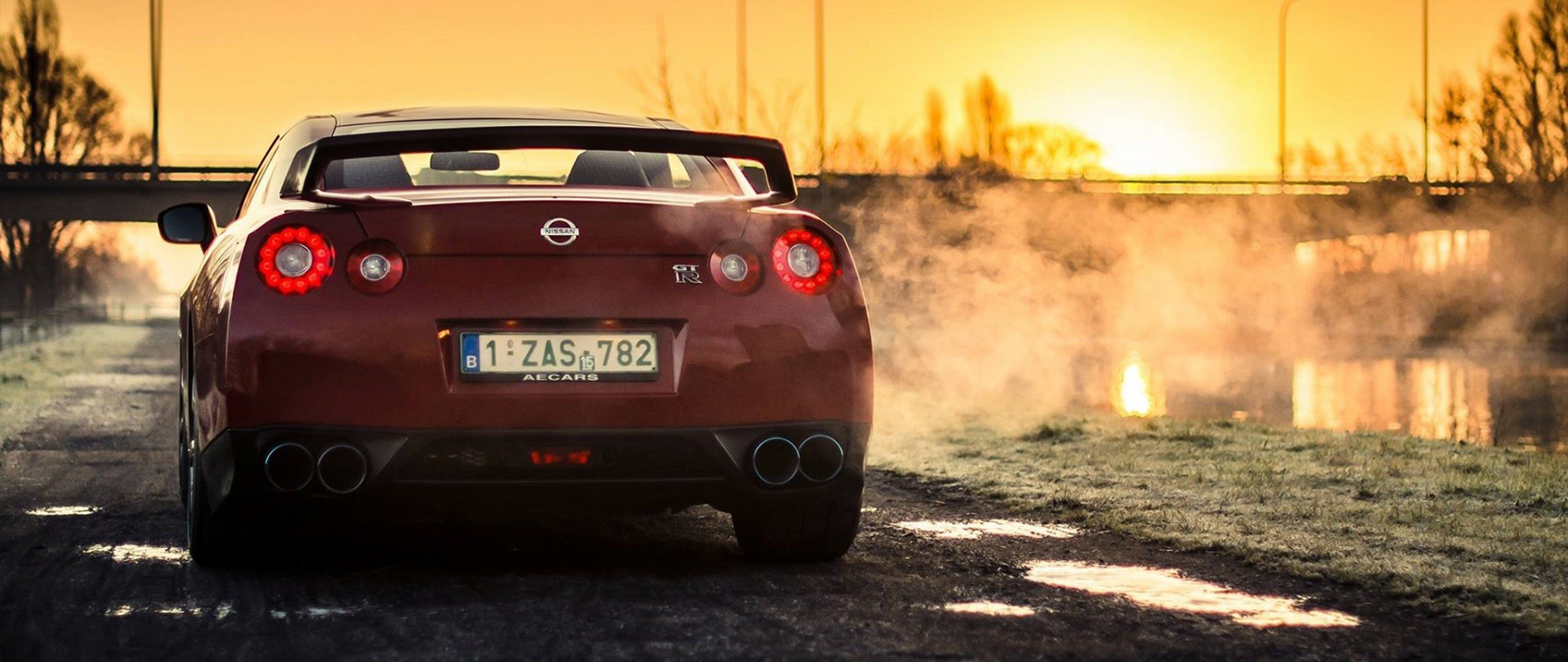 Nissan GT-R R35 on a road at sunset HD Wallpaper