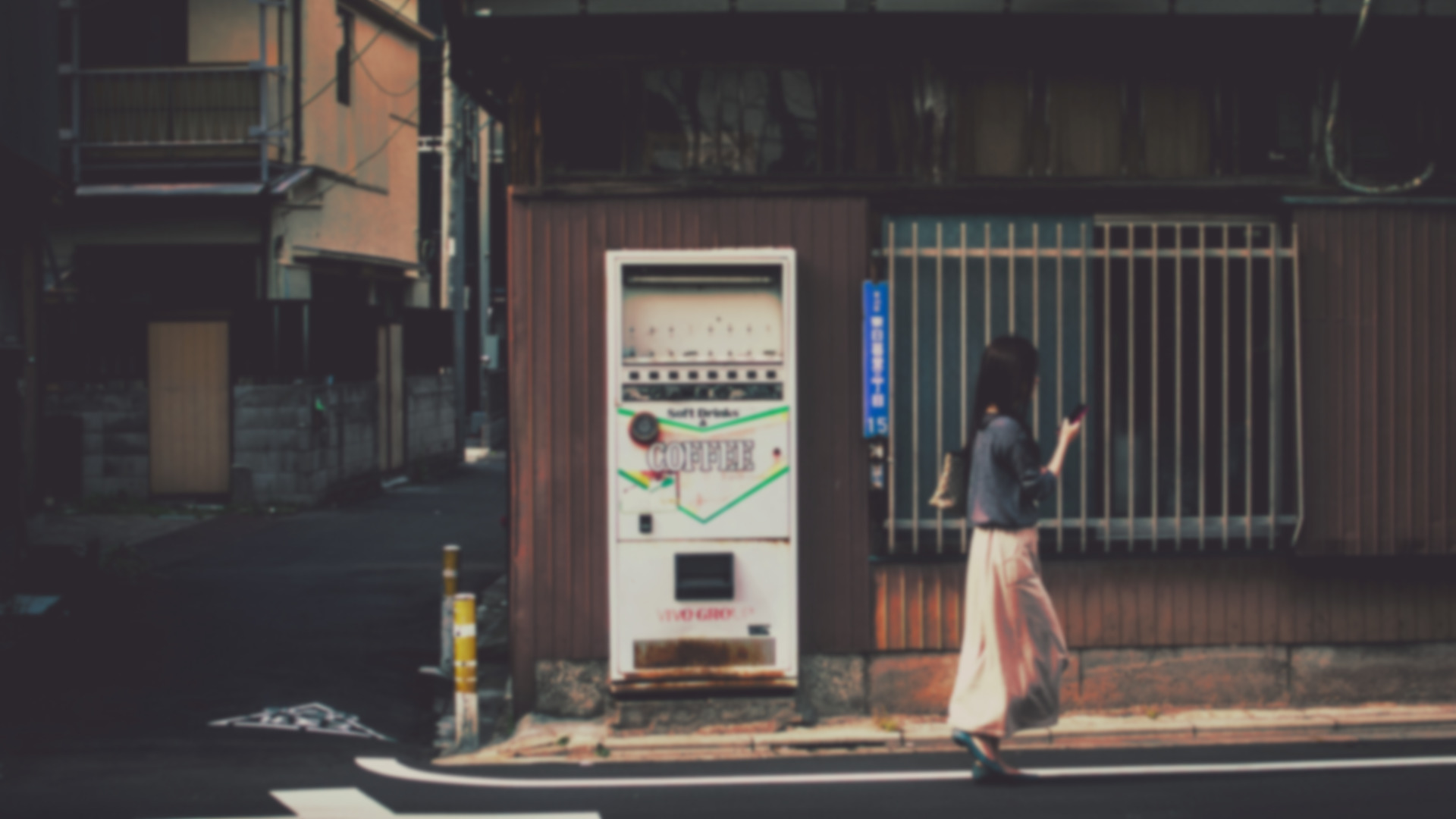 Woman walking past a vending machine in Japan HD Wallpaper