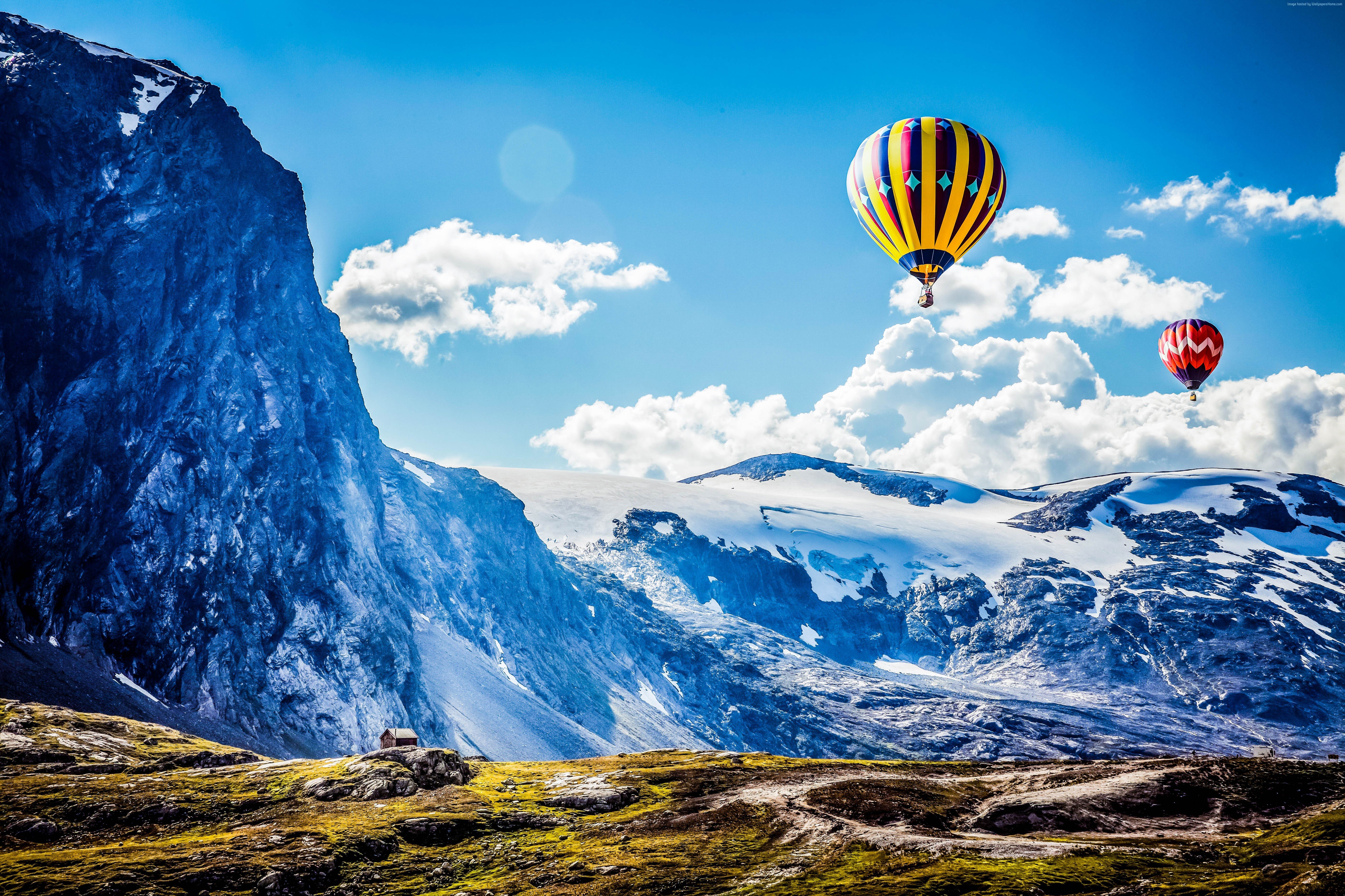 Hot air balloons over snowy mountains HD Wallpaper