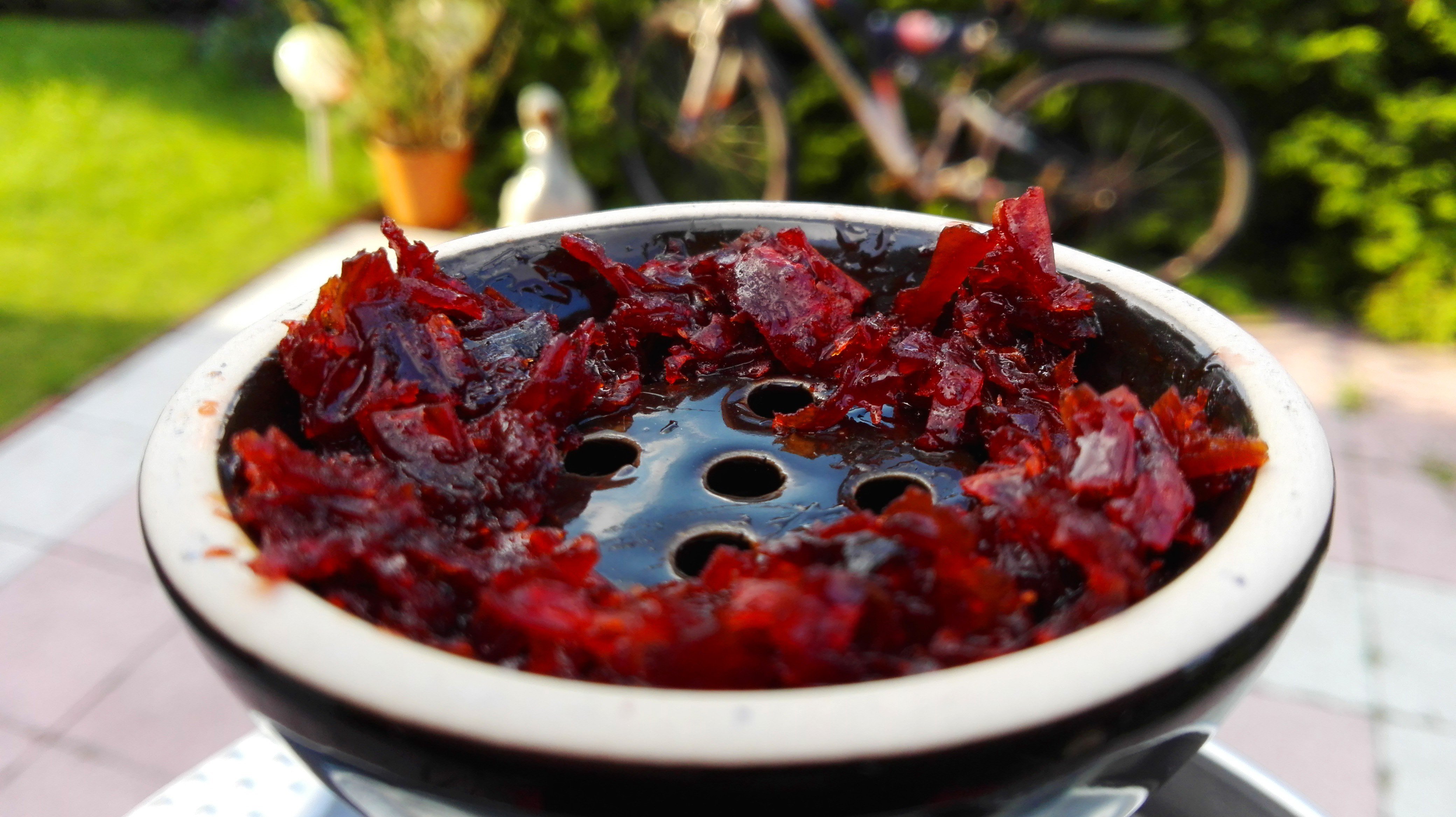 Shisha tobacco in a bowl with a garden background HD Wallpaper
