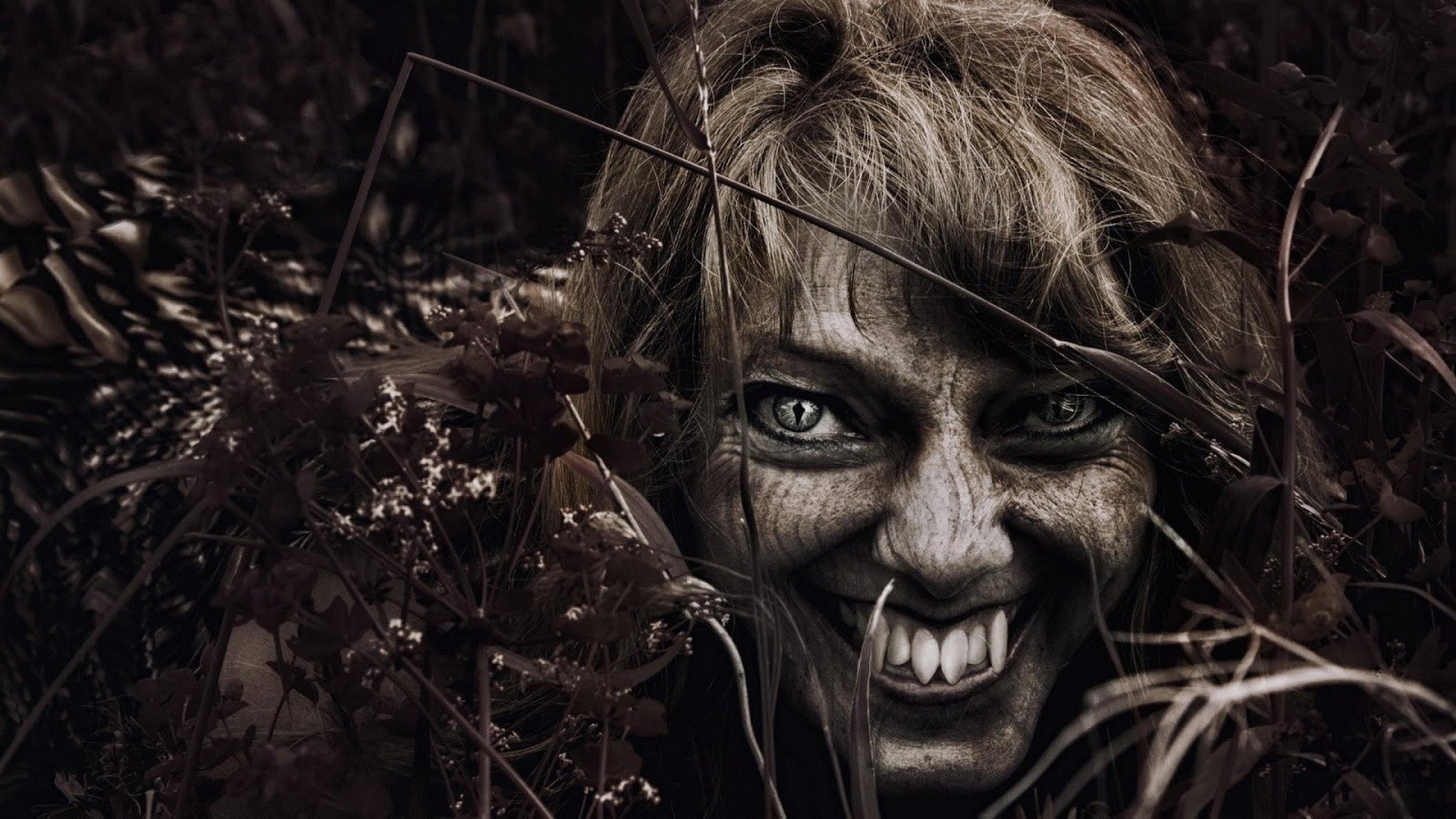 Vampire woman with fangs in dark woods HD Wallpaper