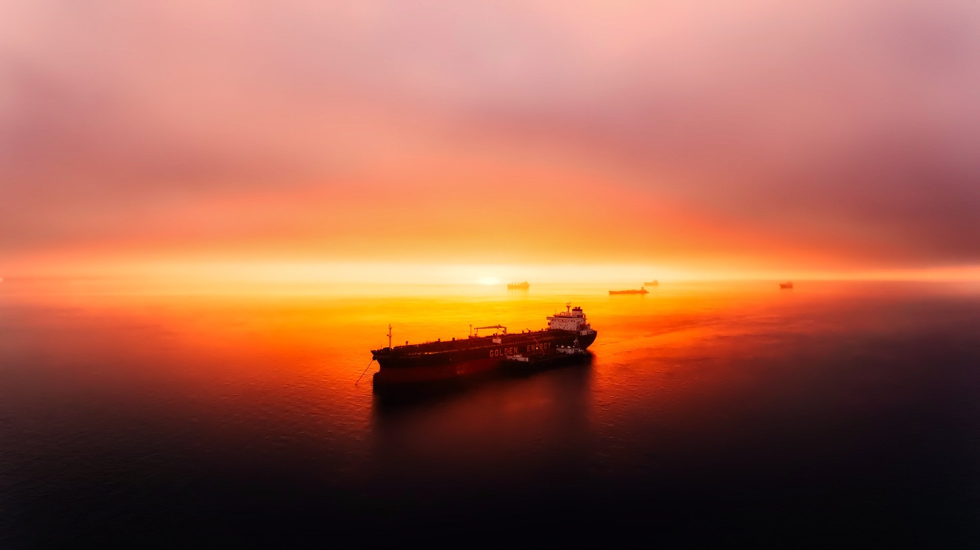 Oil tanker at sunset over the sea HD Wallpaper