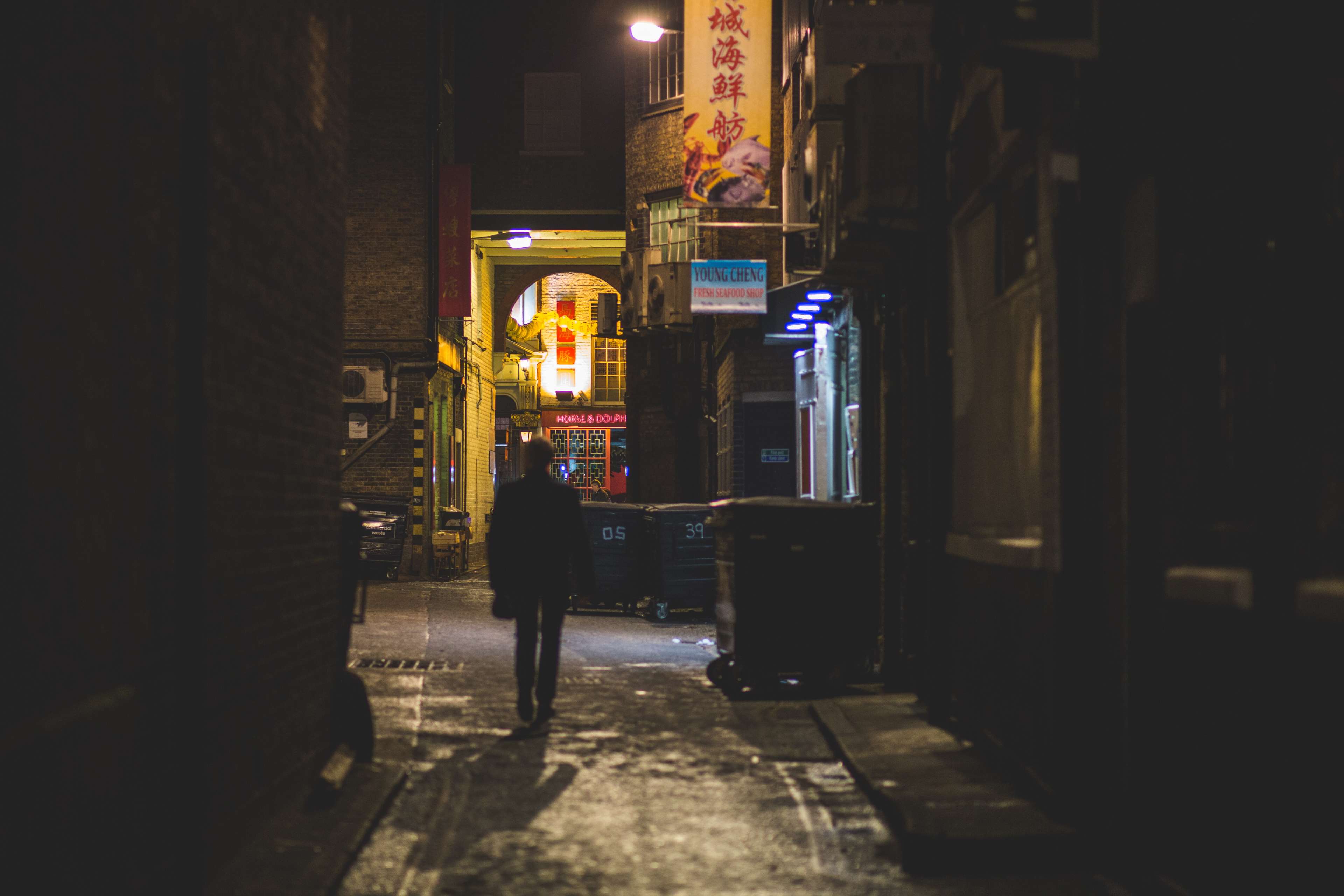 Man walking in a dark Chinatown alley at night 4K HD Wallpaper