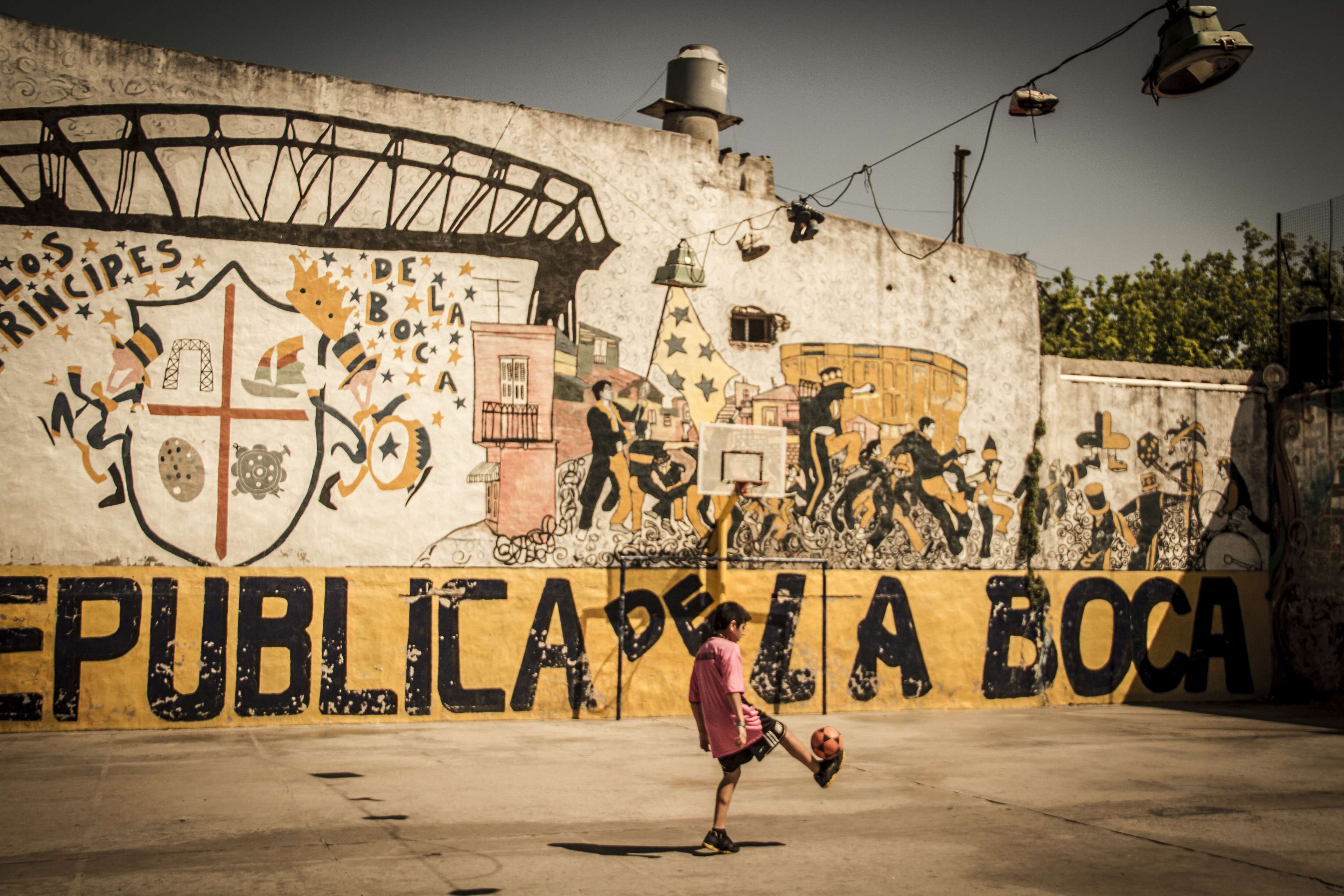 Girl playing soccer in La Boca, Argentina HD Wallpaper