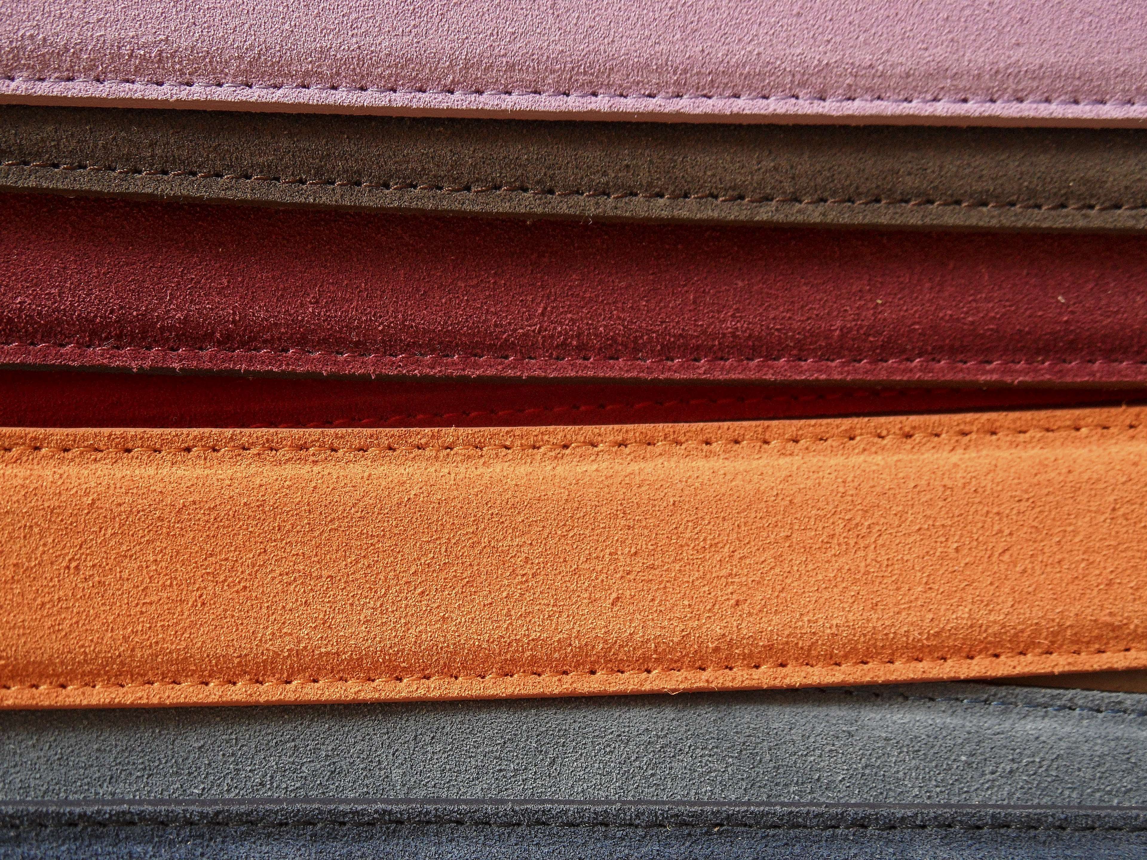Close-up of colorful suede belts with stitching HD Wallpaper
