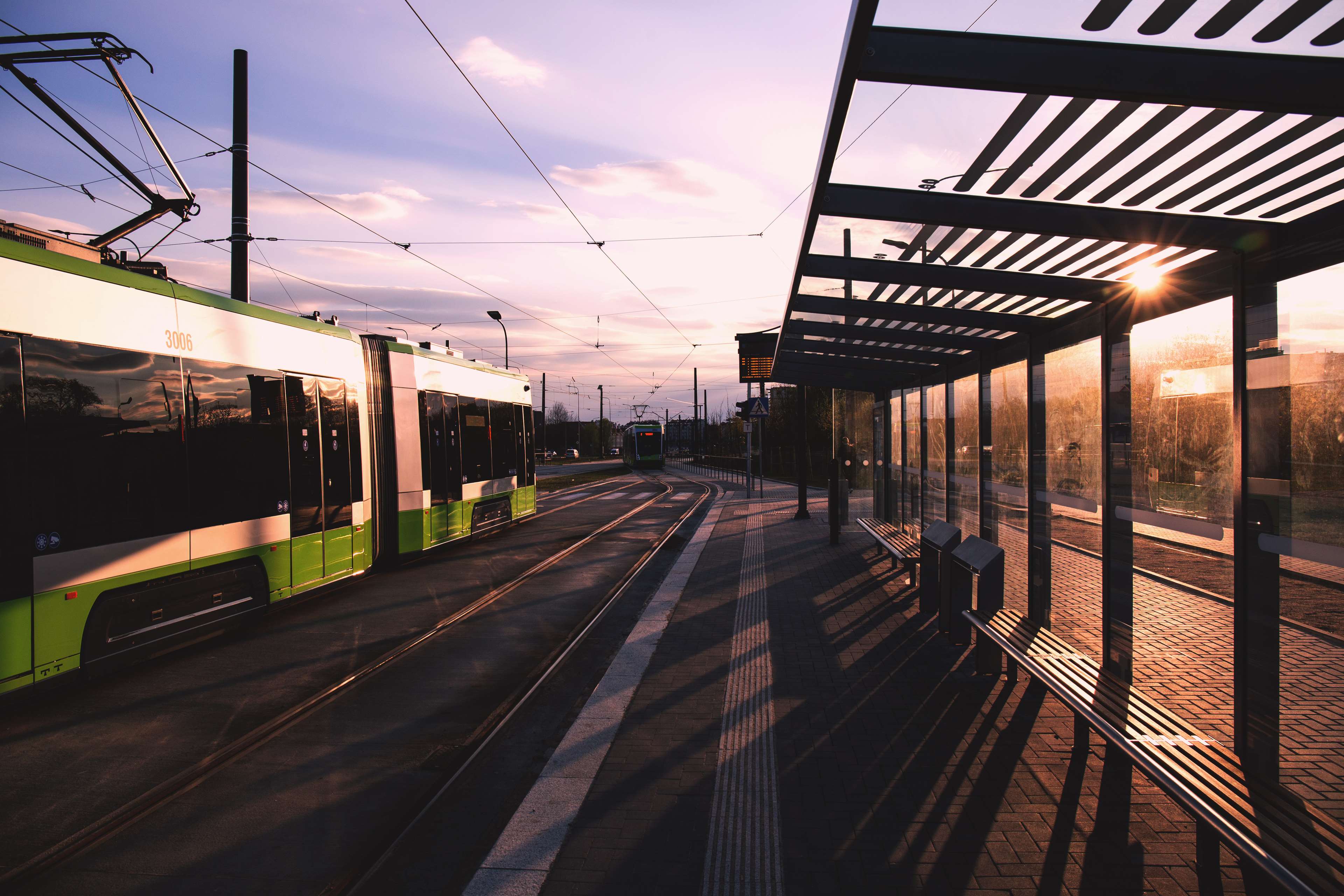 Tram at a station during sunset HD Wallpaper