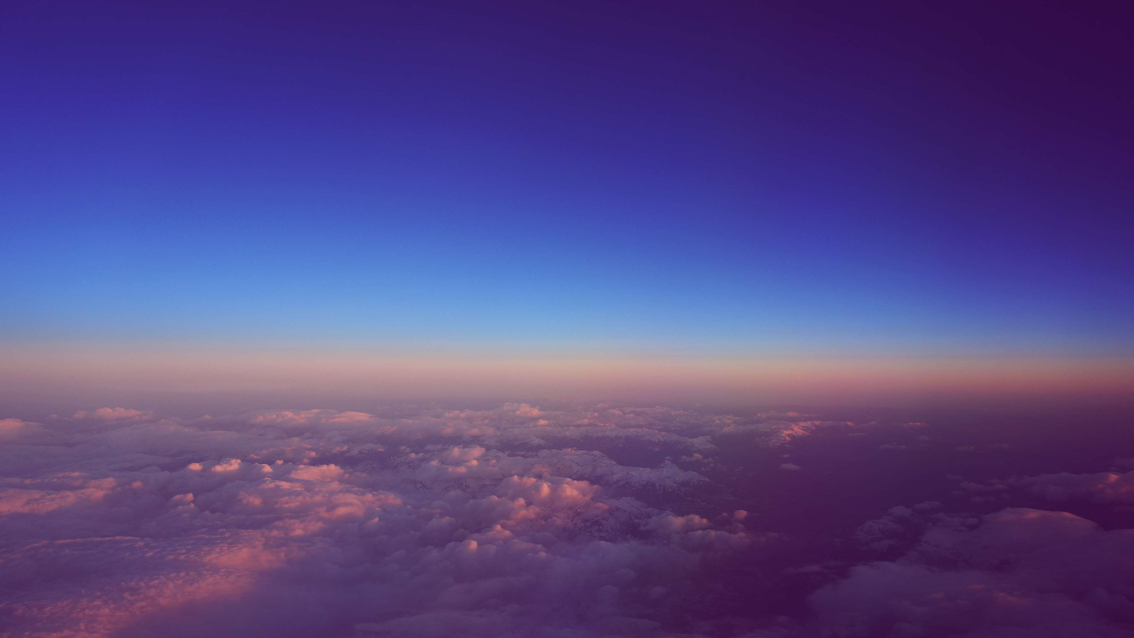 Sunset over clouds from airplane window HD Wallpaper