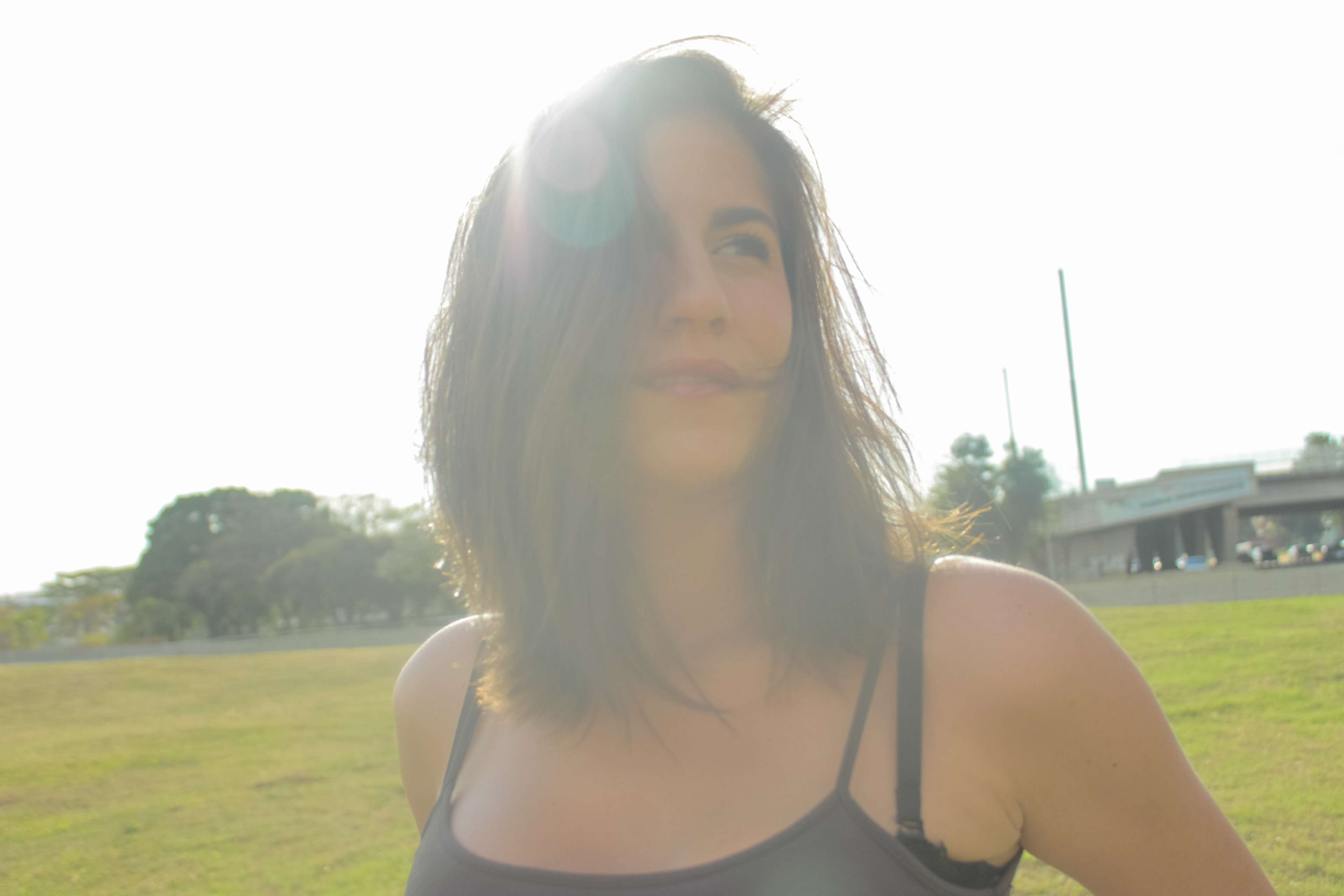 Woman in a black tank top in a park HD Wallpaper