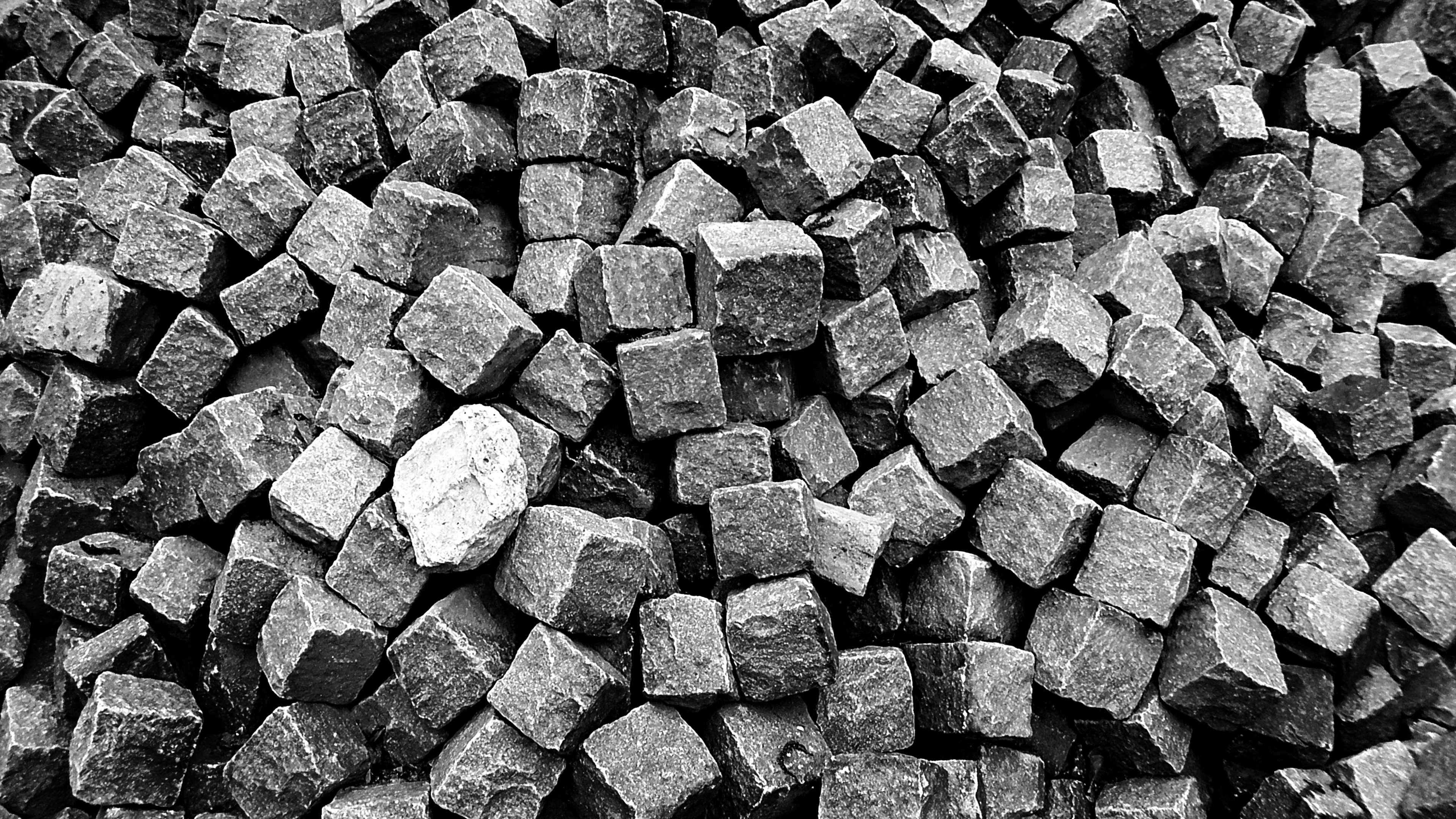 Pile of rough-hewn stone blocks HD Wallpaper