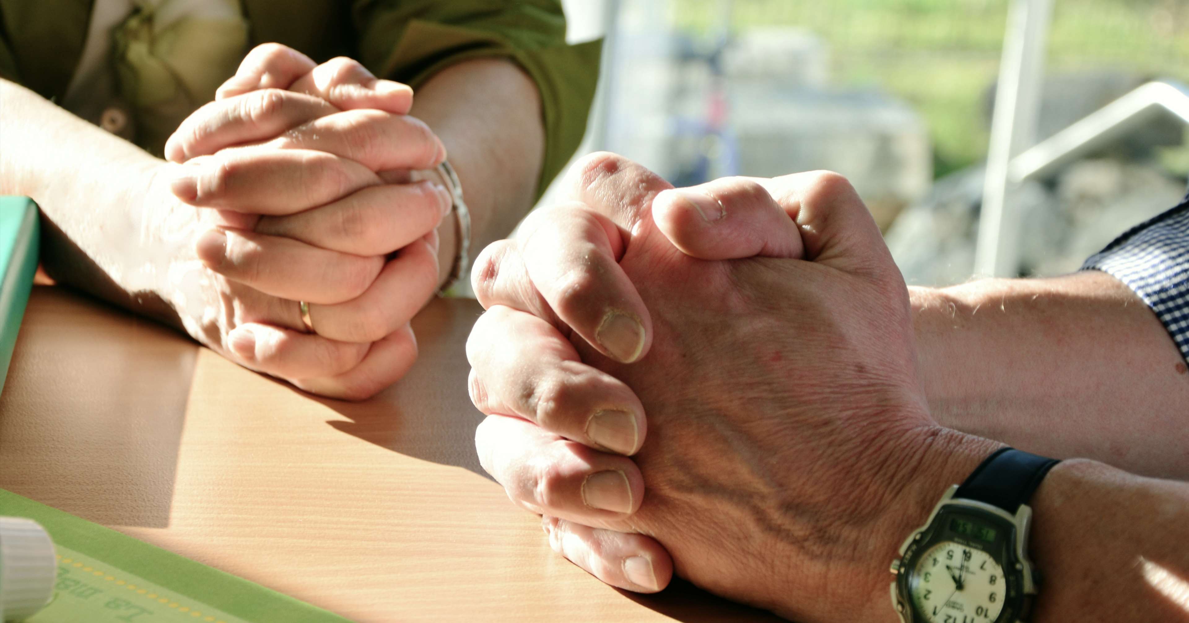 Two people praying with clasped hands HD Wallpaper