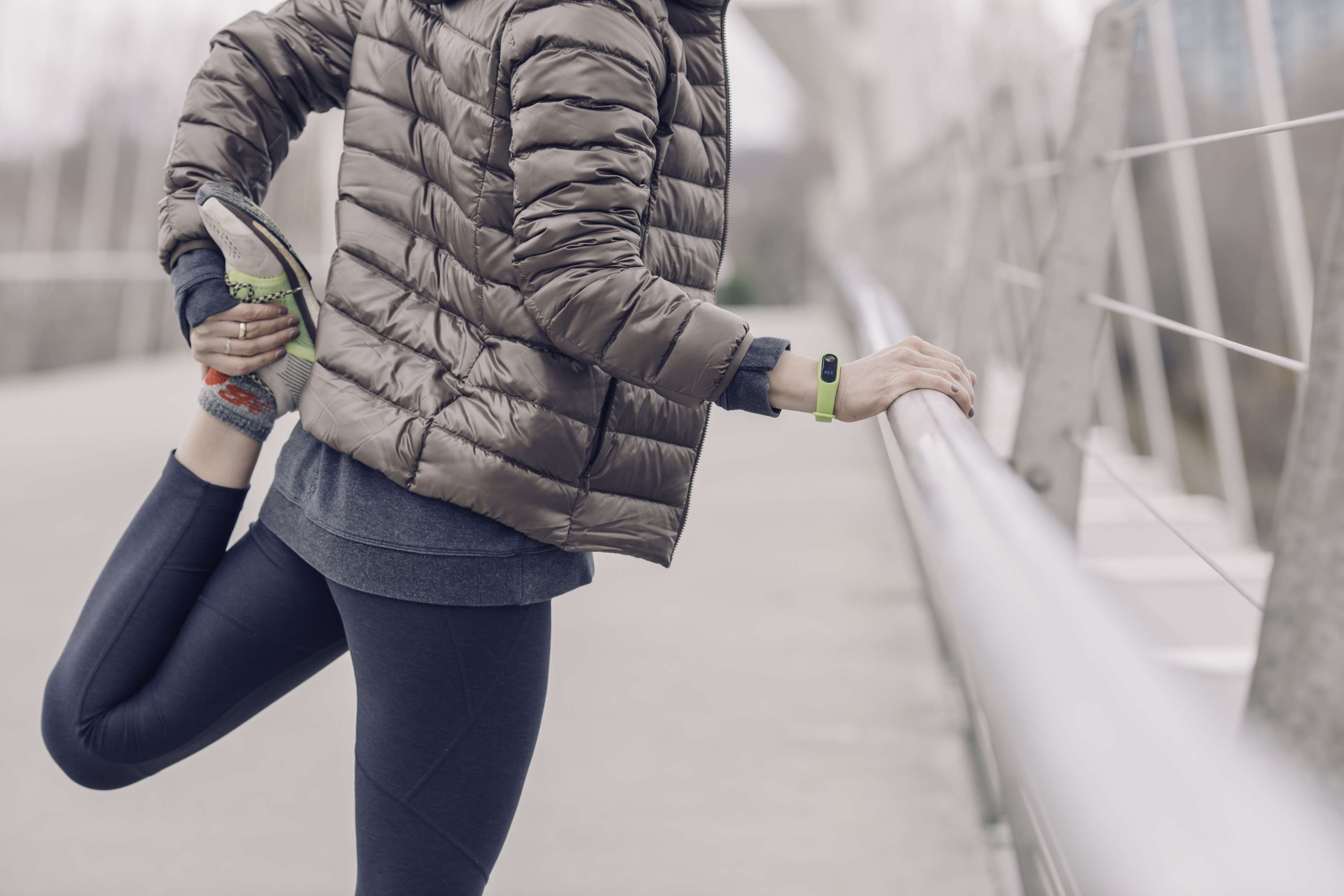 Woman stretching on a bridge railing HD Wallpaper