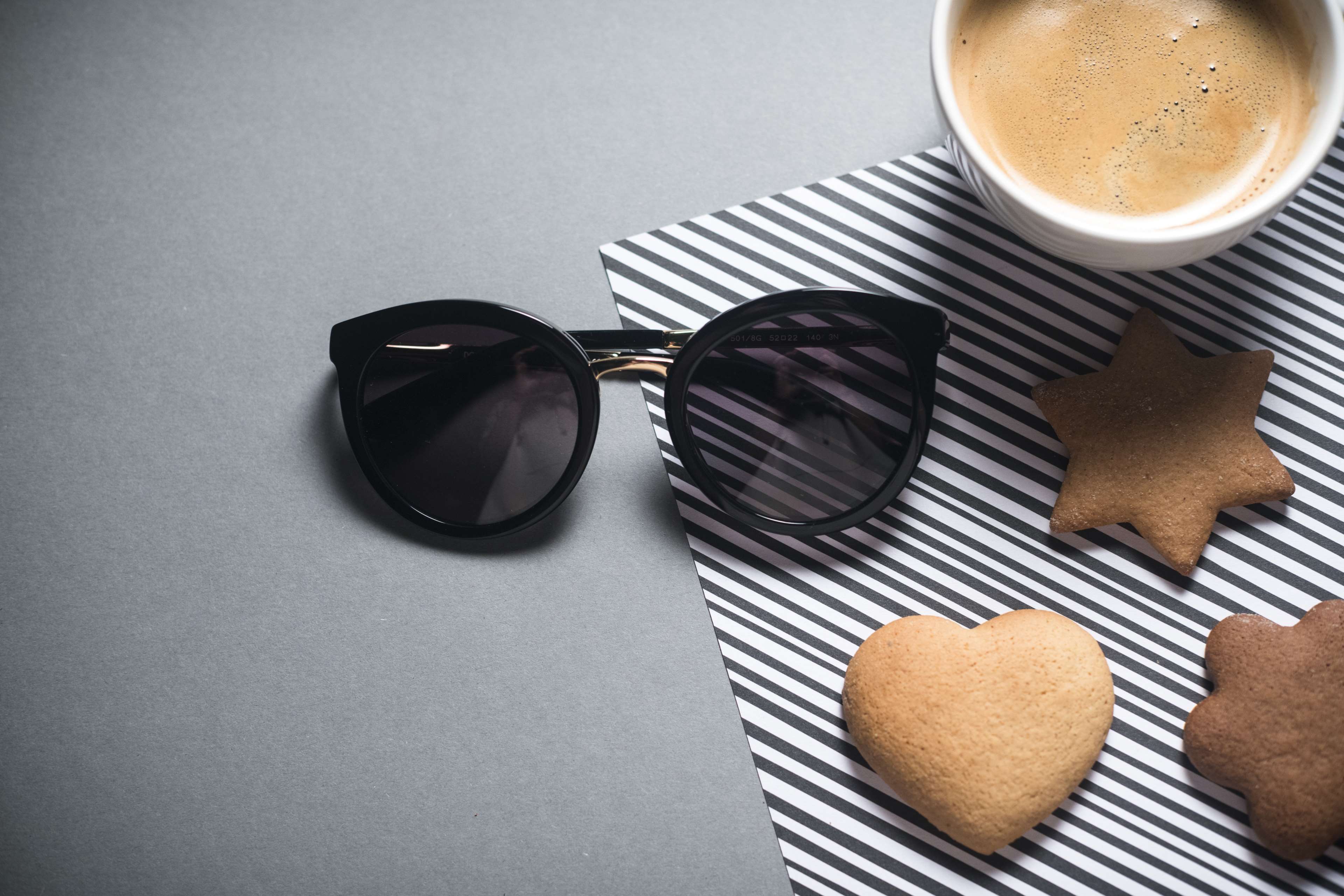 Sunglasses and cookies with coffee on striped paper HD Wallpaper