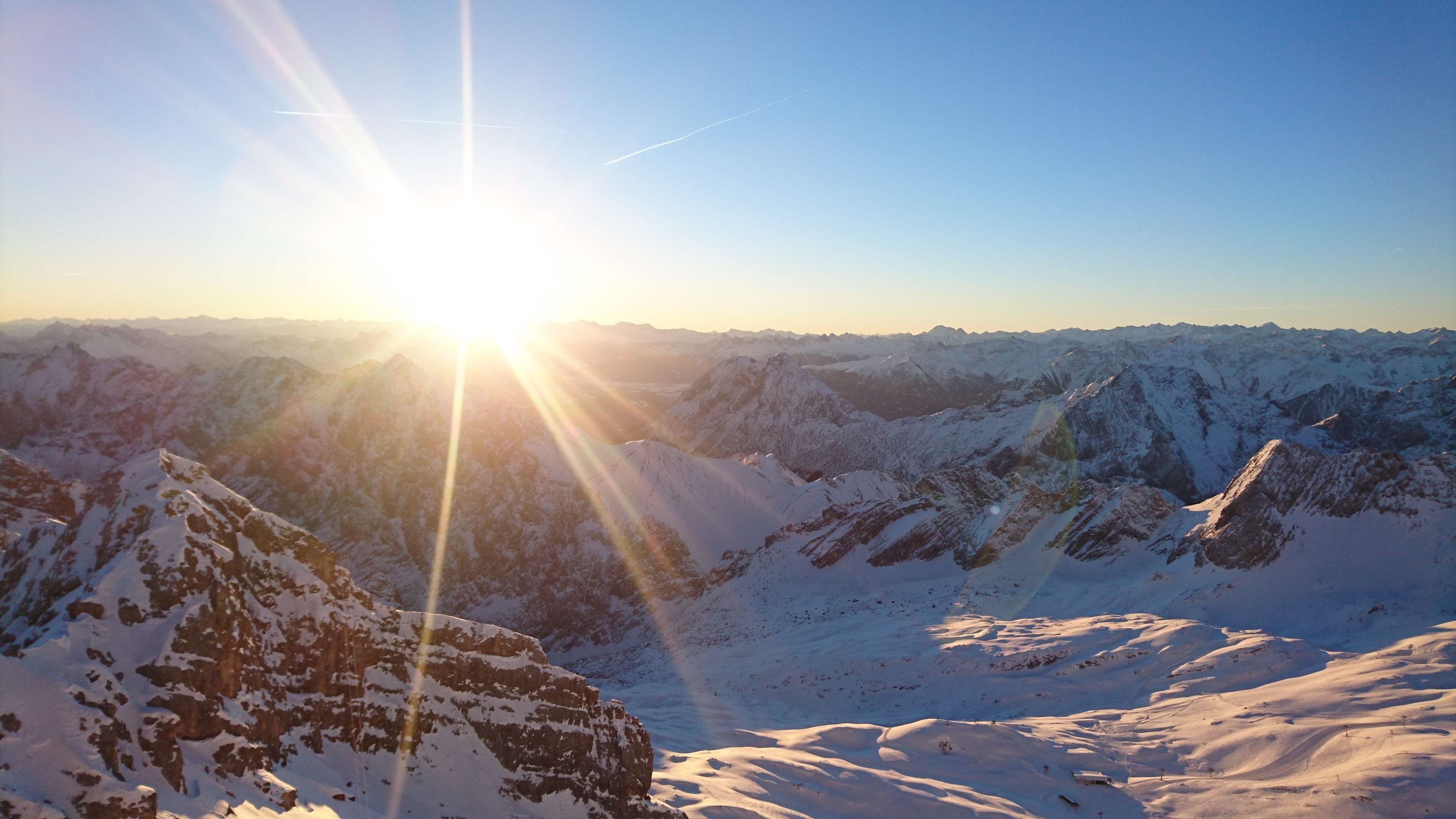 Sunrise over snow-covered mountains HD Wallpaper