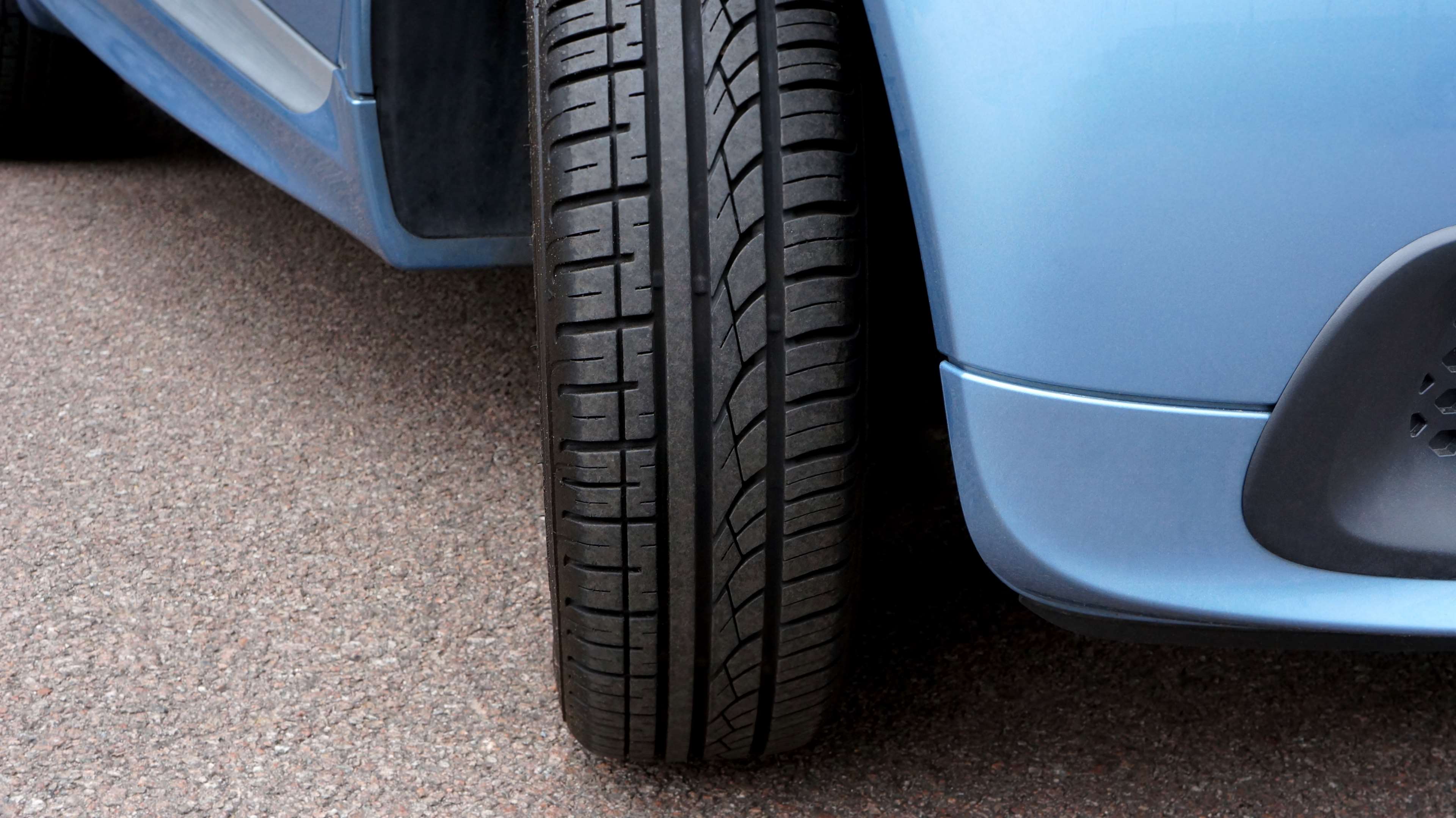 Blue car tire on asphalt HD Wallpaper