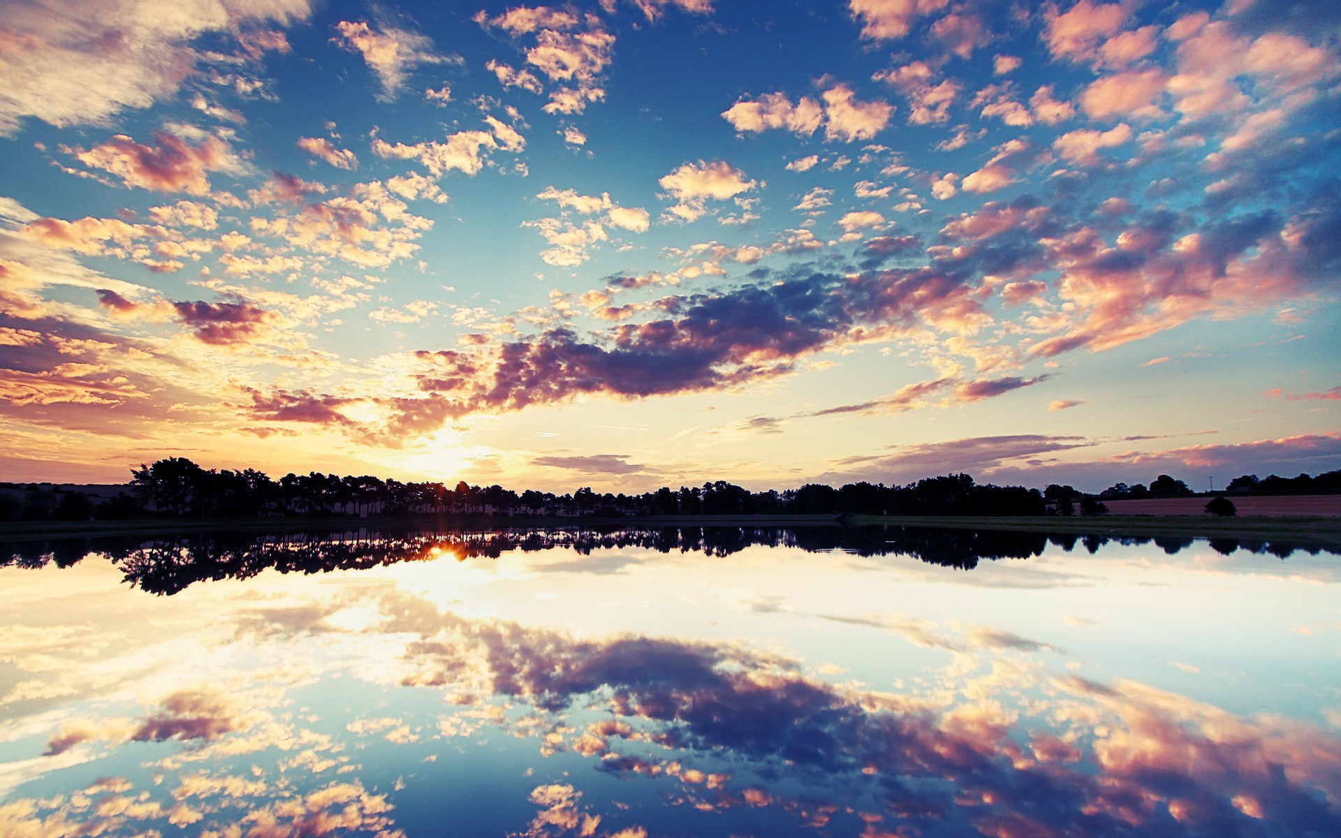 Sunset over a calm lake with colorful clouds HD Wallpaper