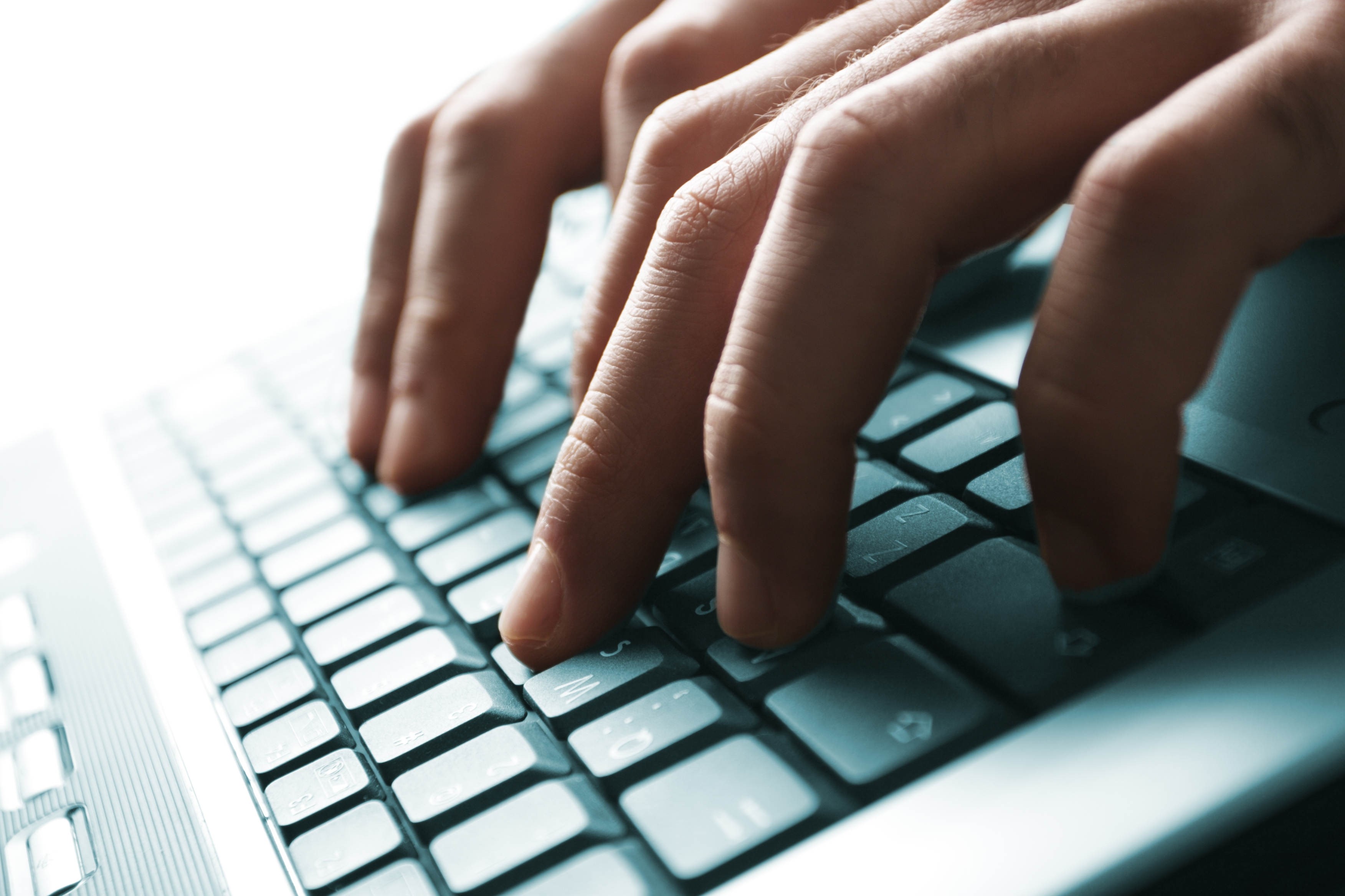 Hands typing on a laptop keyboard HD Wallpaper
