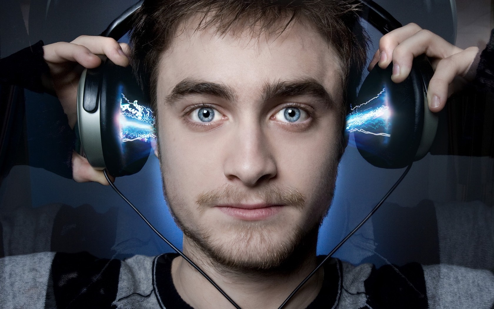 Daniel Radcliffe wearing headphones with electrical effects HD Wallpaper