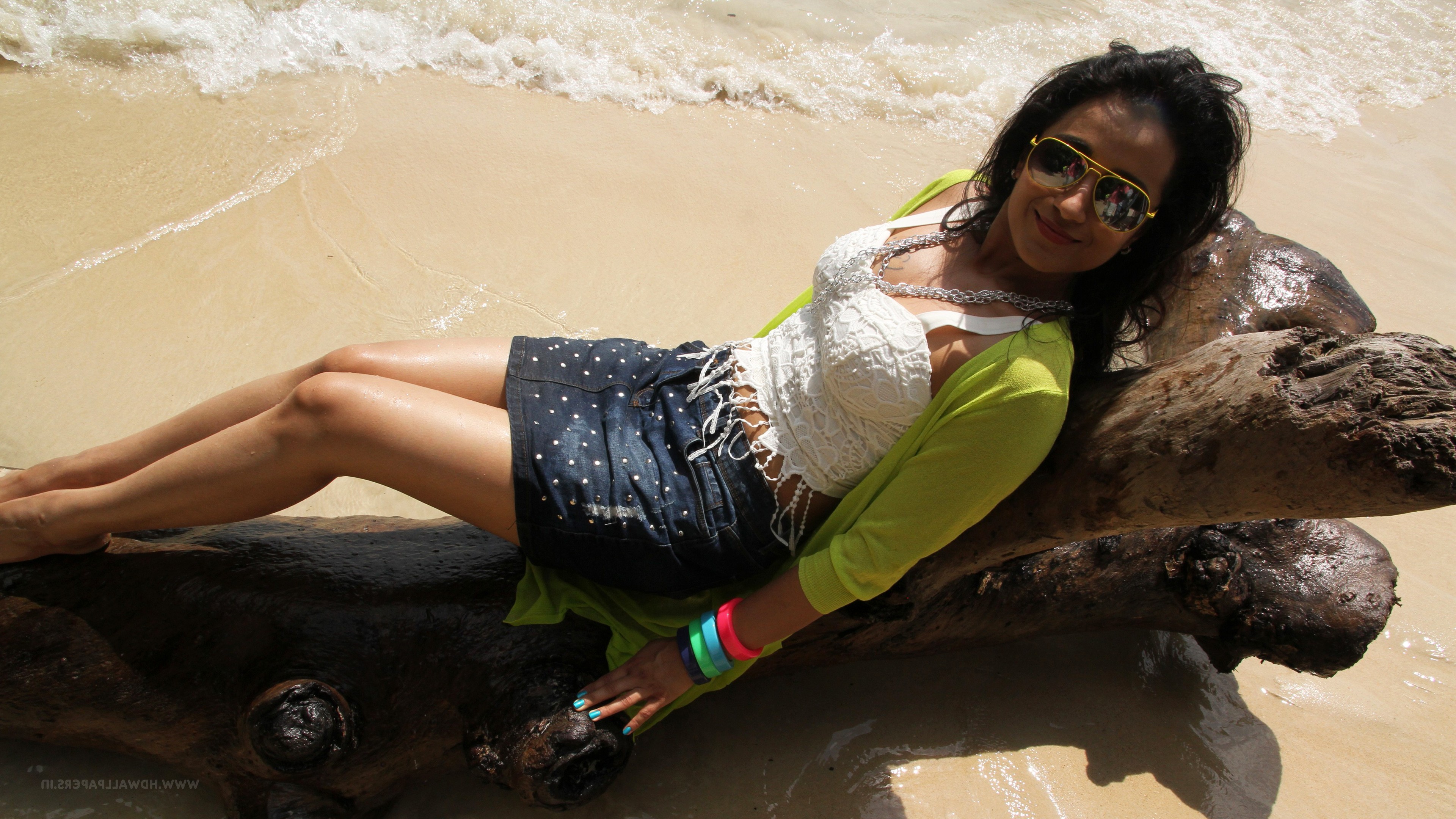 Trisha Krishnan on a beach lying on a log HD Wallpaper