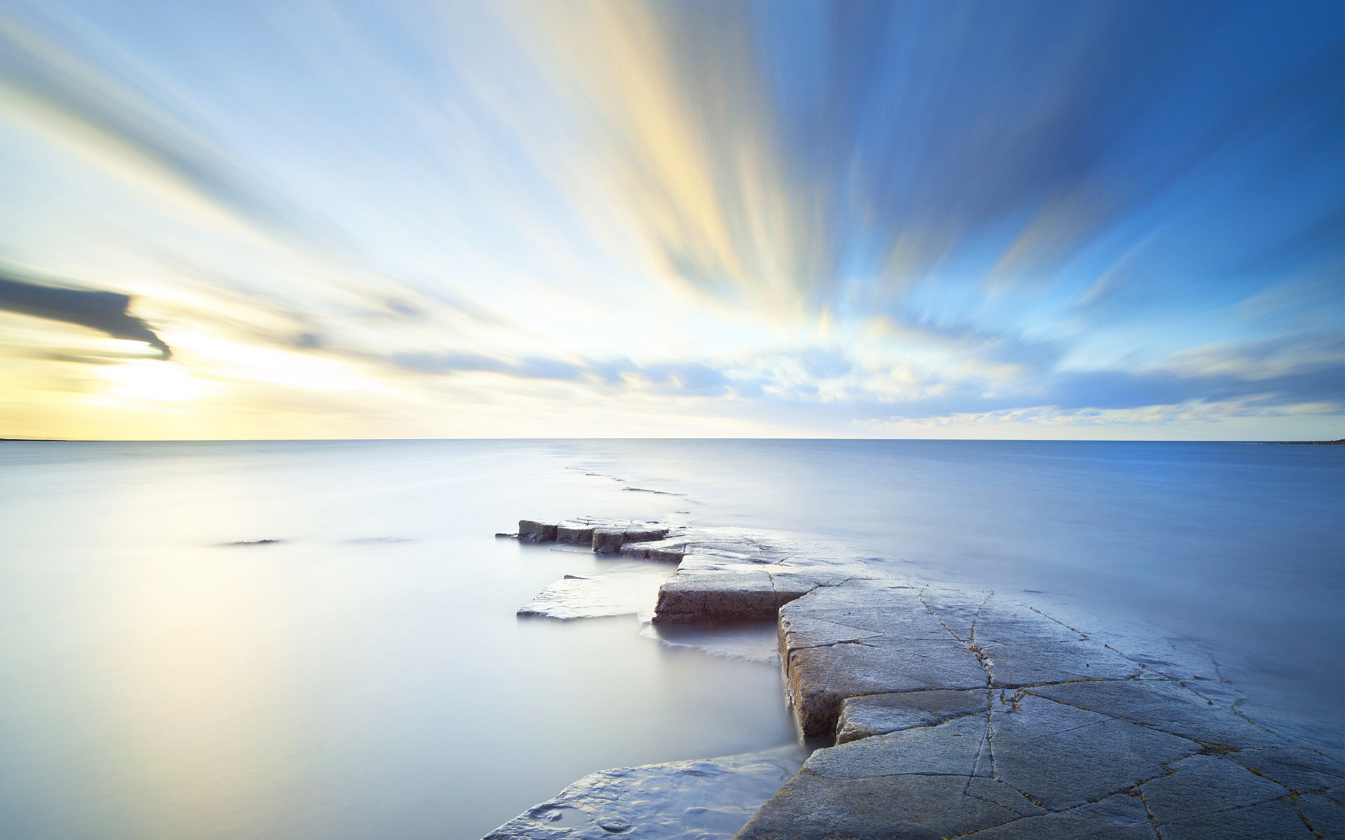 Long exposure of sea and sky with rocks HD Wallpaper
