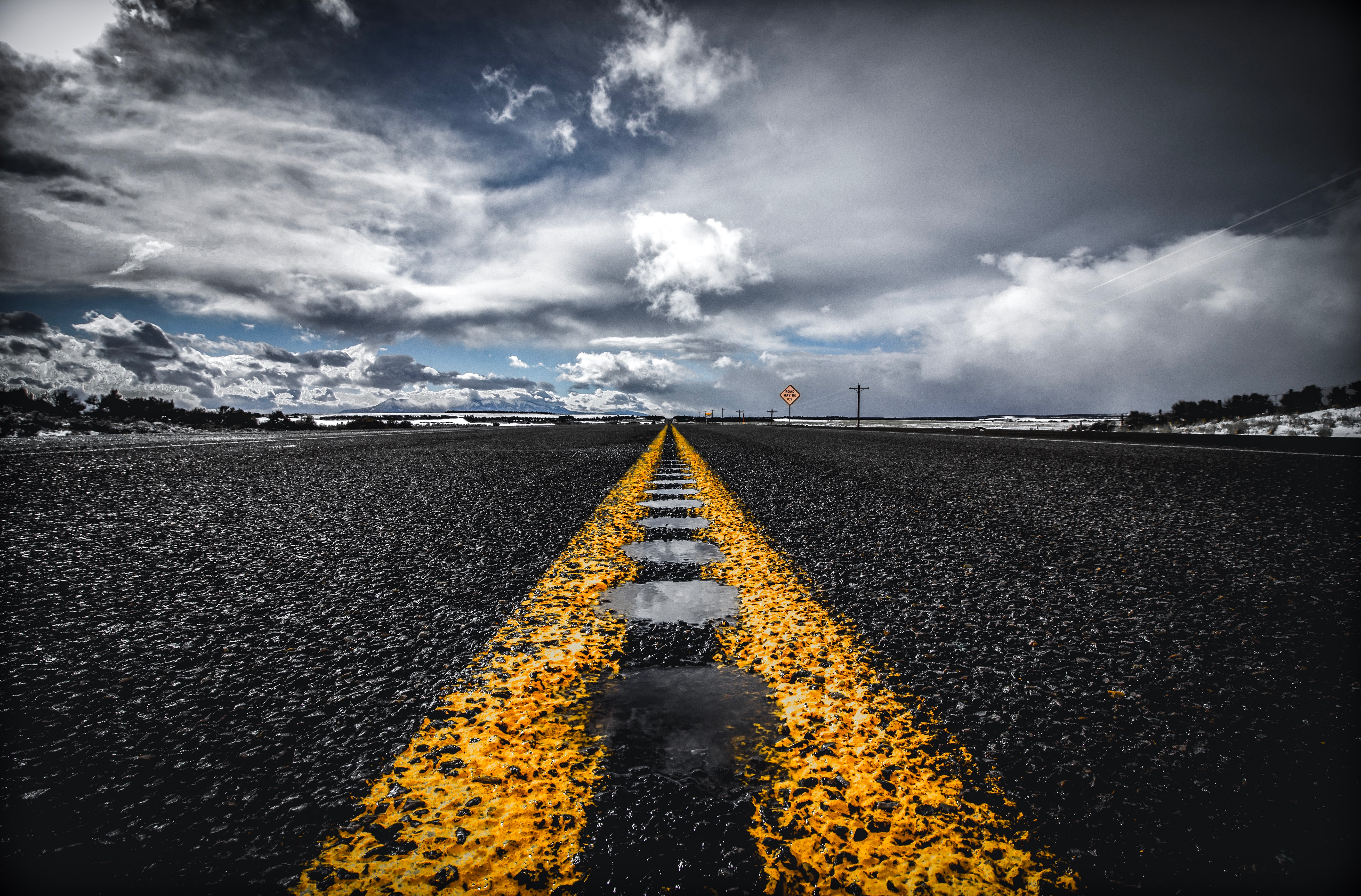 Empty Road with Yellow Line and Cloudy Sky HD Wallpaper