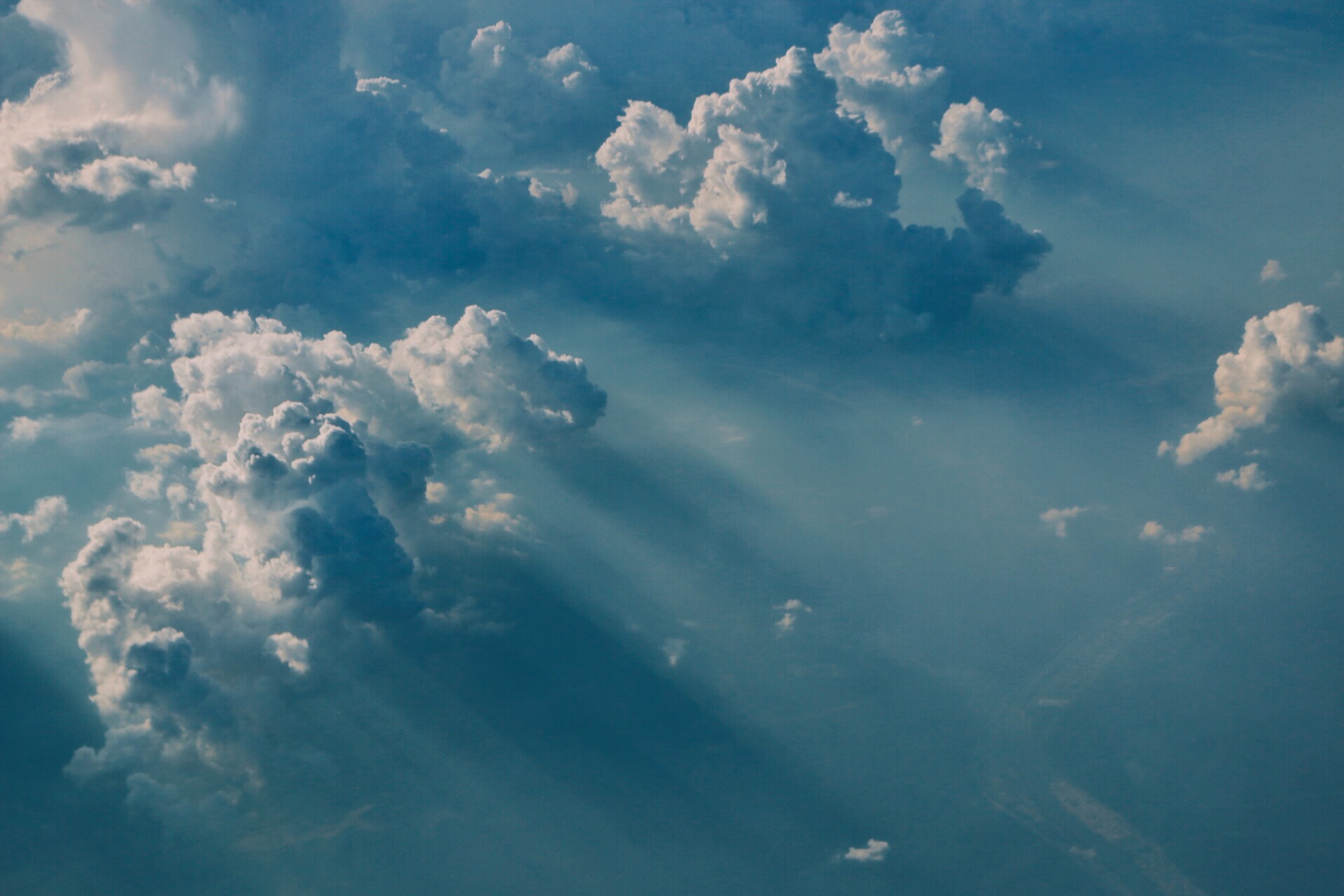 Sunlight beams through dramatic clouds in the sky HD Wallpaper