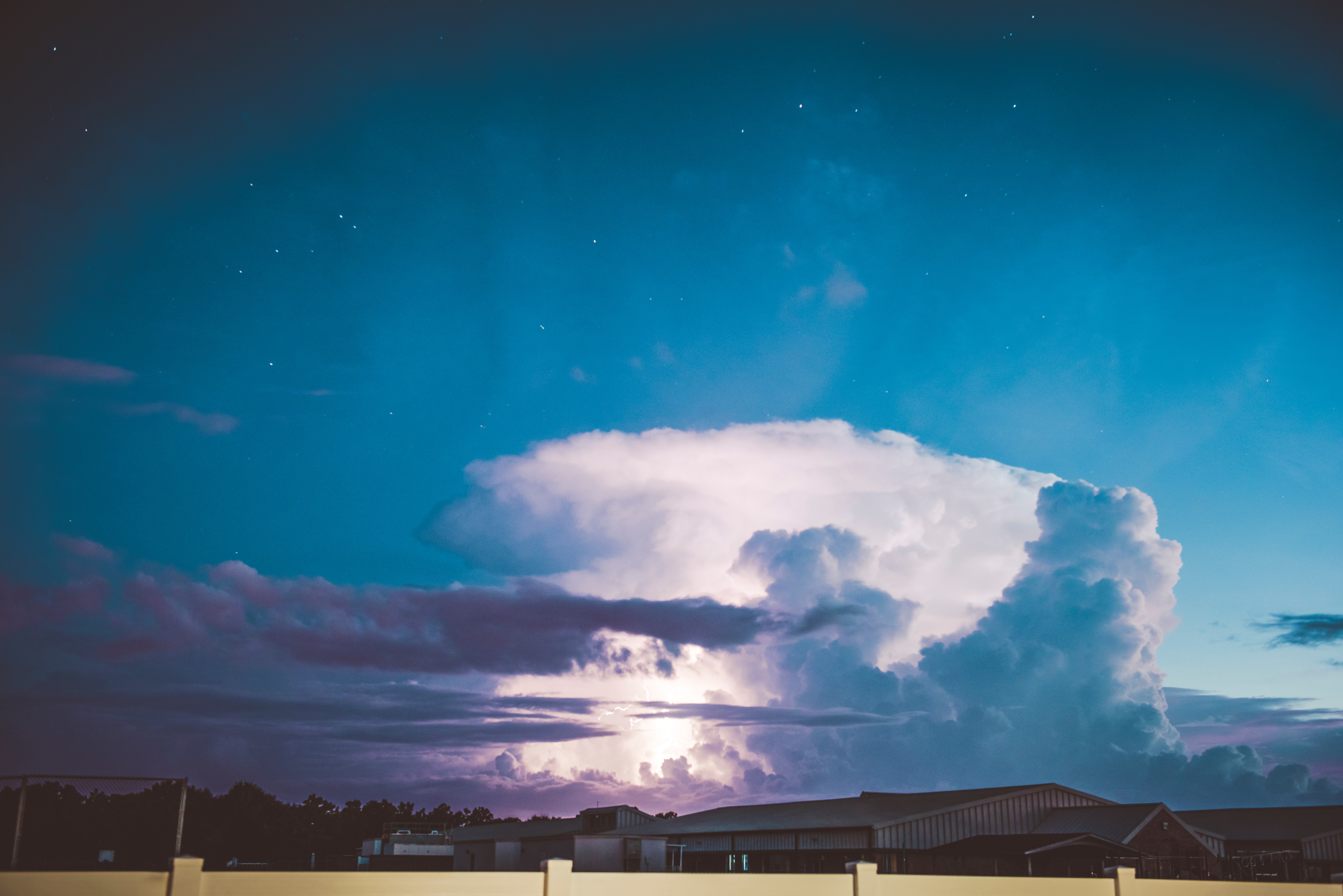 Lightning storm over buildings at night HD Wallpaper