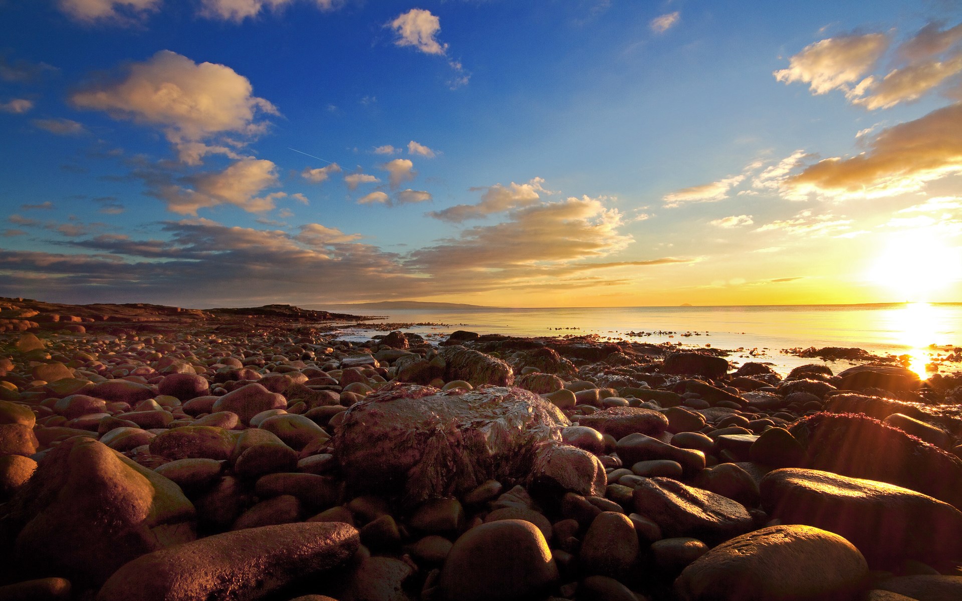 Rocky beach at sunset with ocean and clouds HD Wallpaper