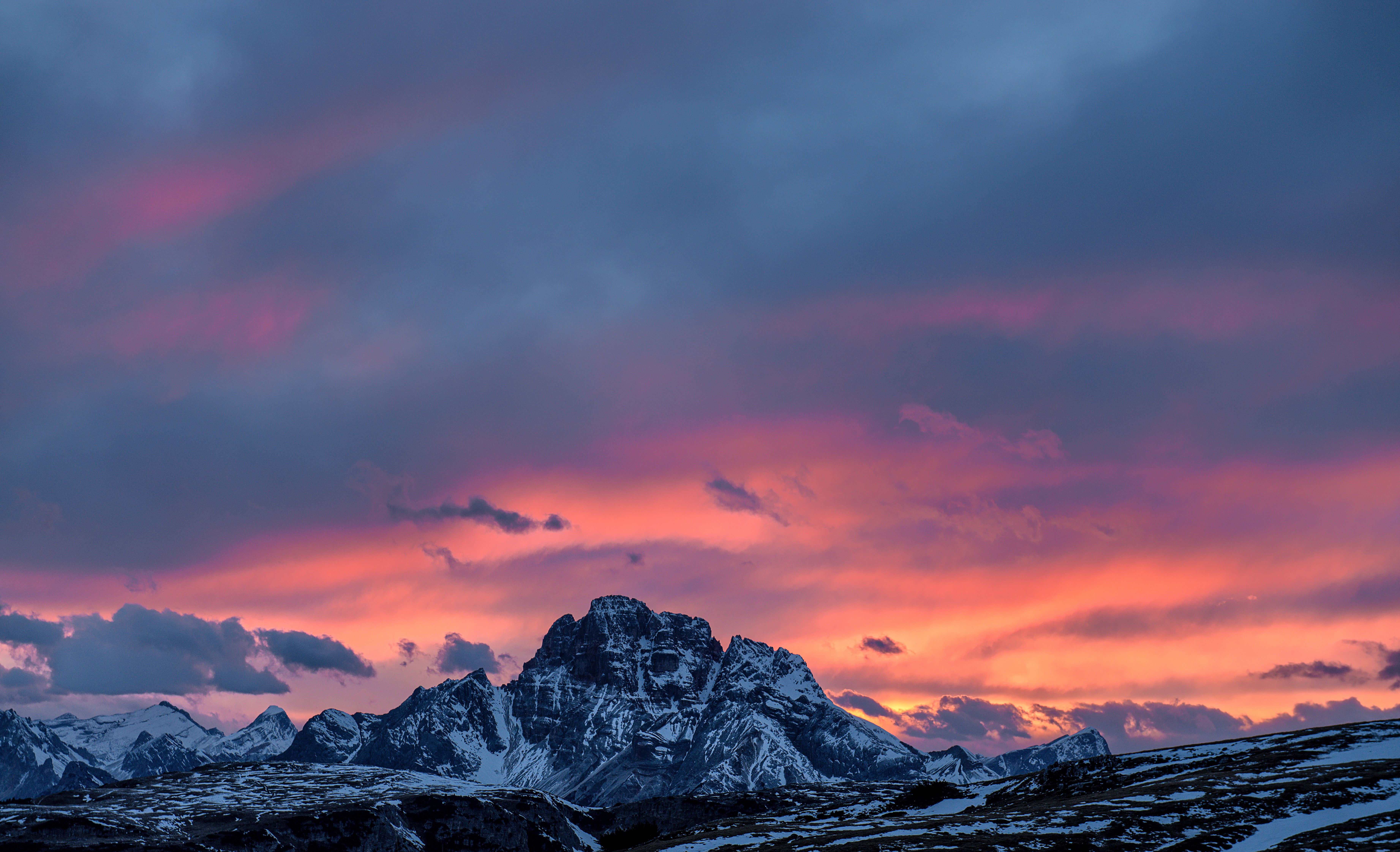 Snowy mountain range at sunset with colorful clouds HD Wallpaper