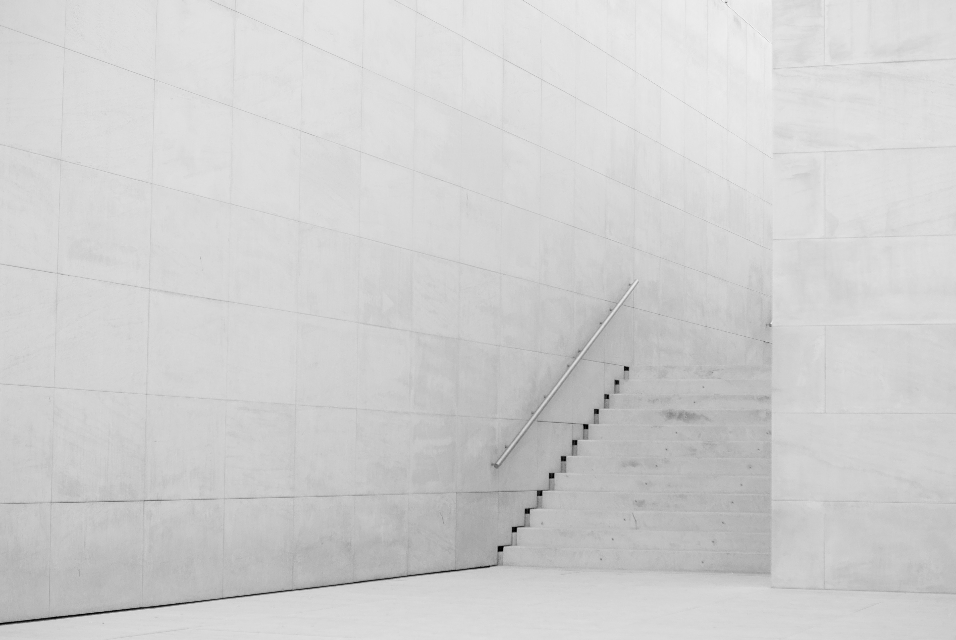 Minimalist white interior with concrete stairs and railing HD Wallpaper