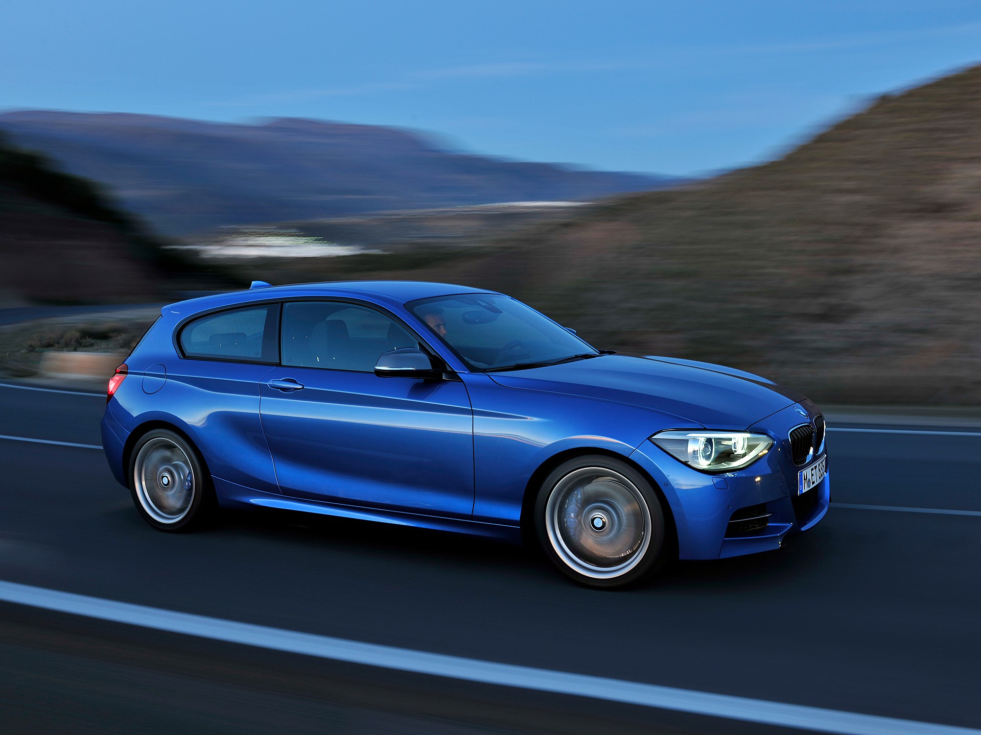 Blue 2013 BMW 1 Series driving on a road HD Wallpaper