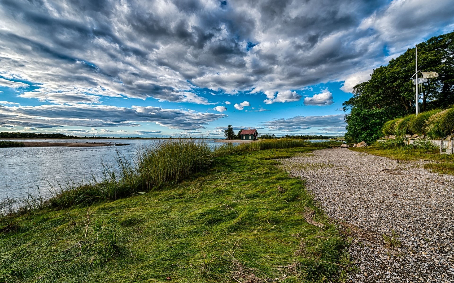 House by the water under a cloudy sky HD Wallpaper