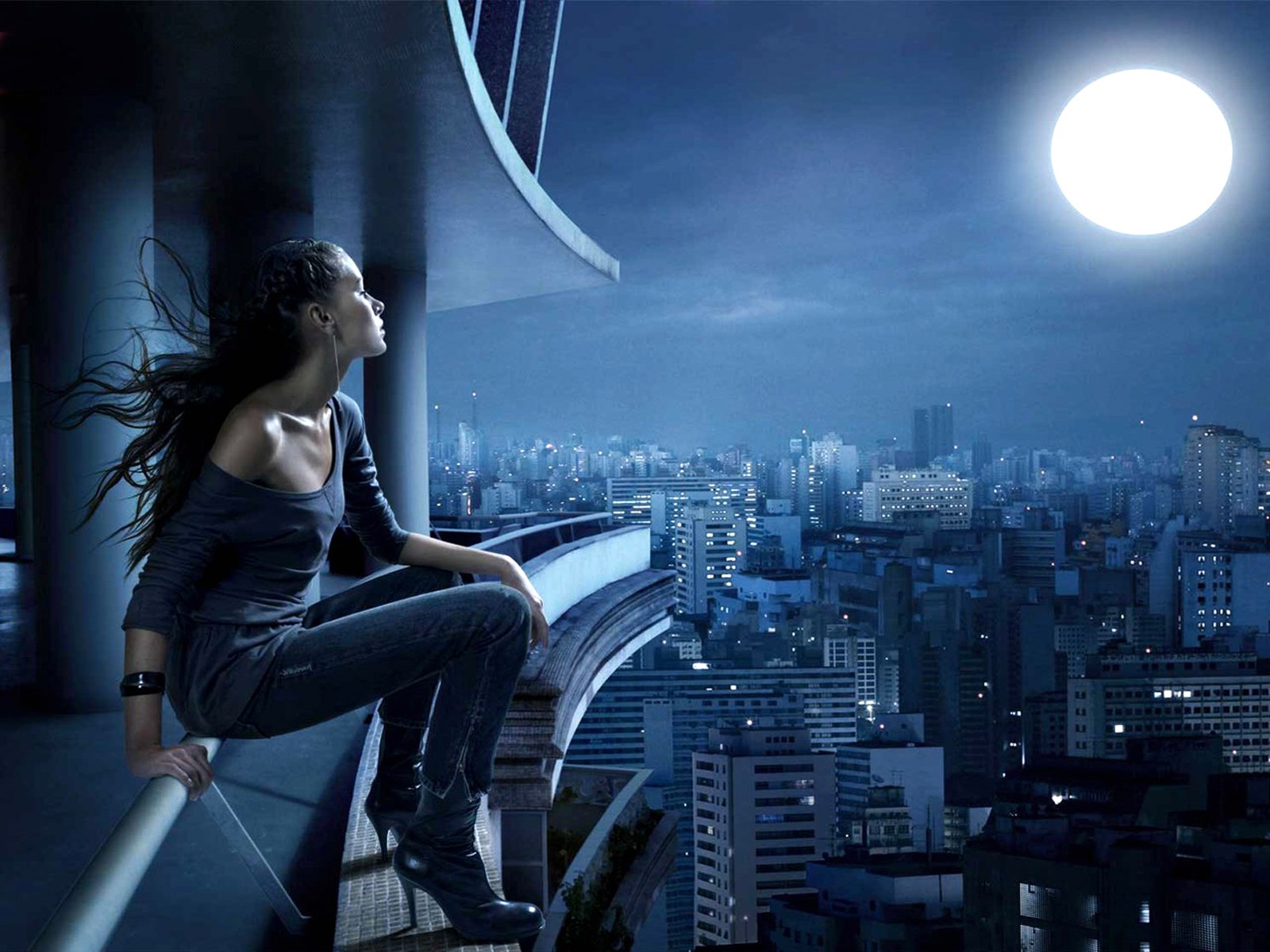 Woman on balcony overlooking city at night HD Wallpaper