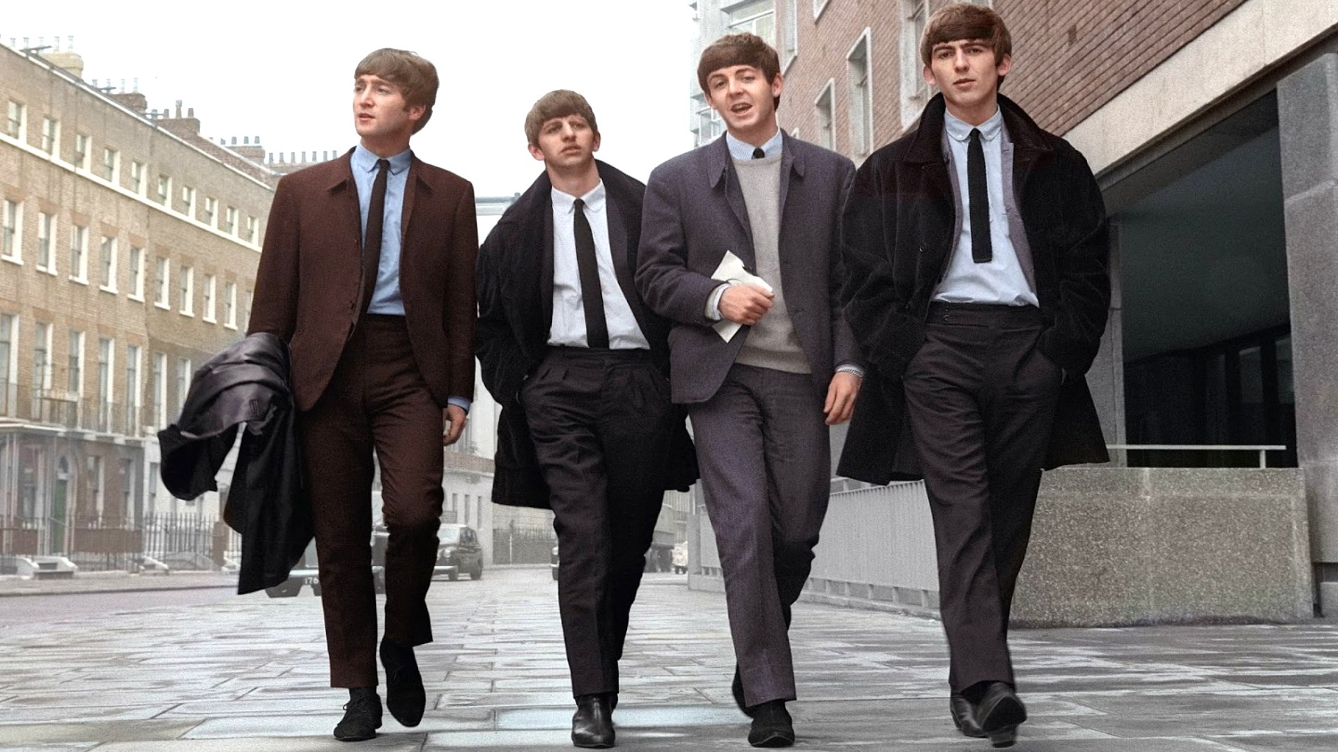 The Beatles walking down a street HD Wallpaper