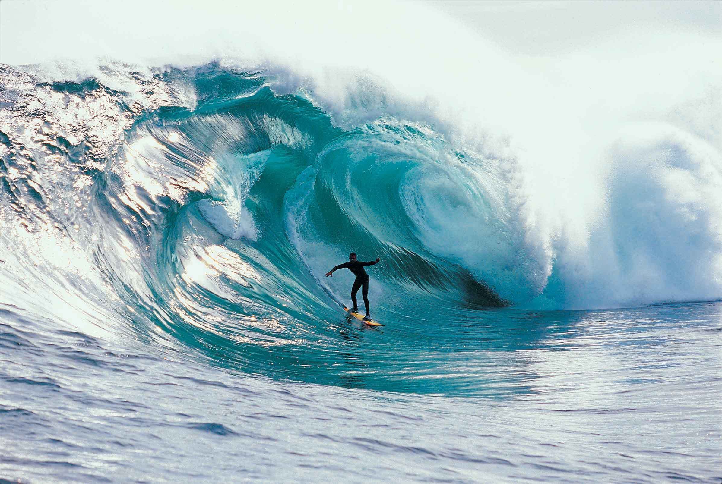 Surfer riding a massive wave HD Wallpaper