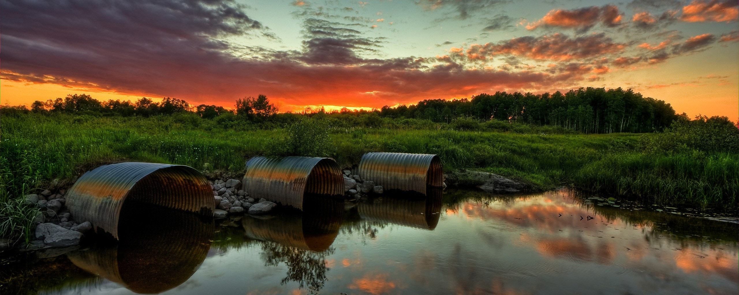 Three culverts in a stream at sunset HD Wallpaper