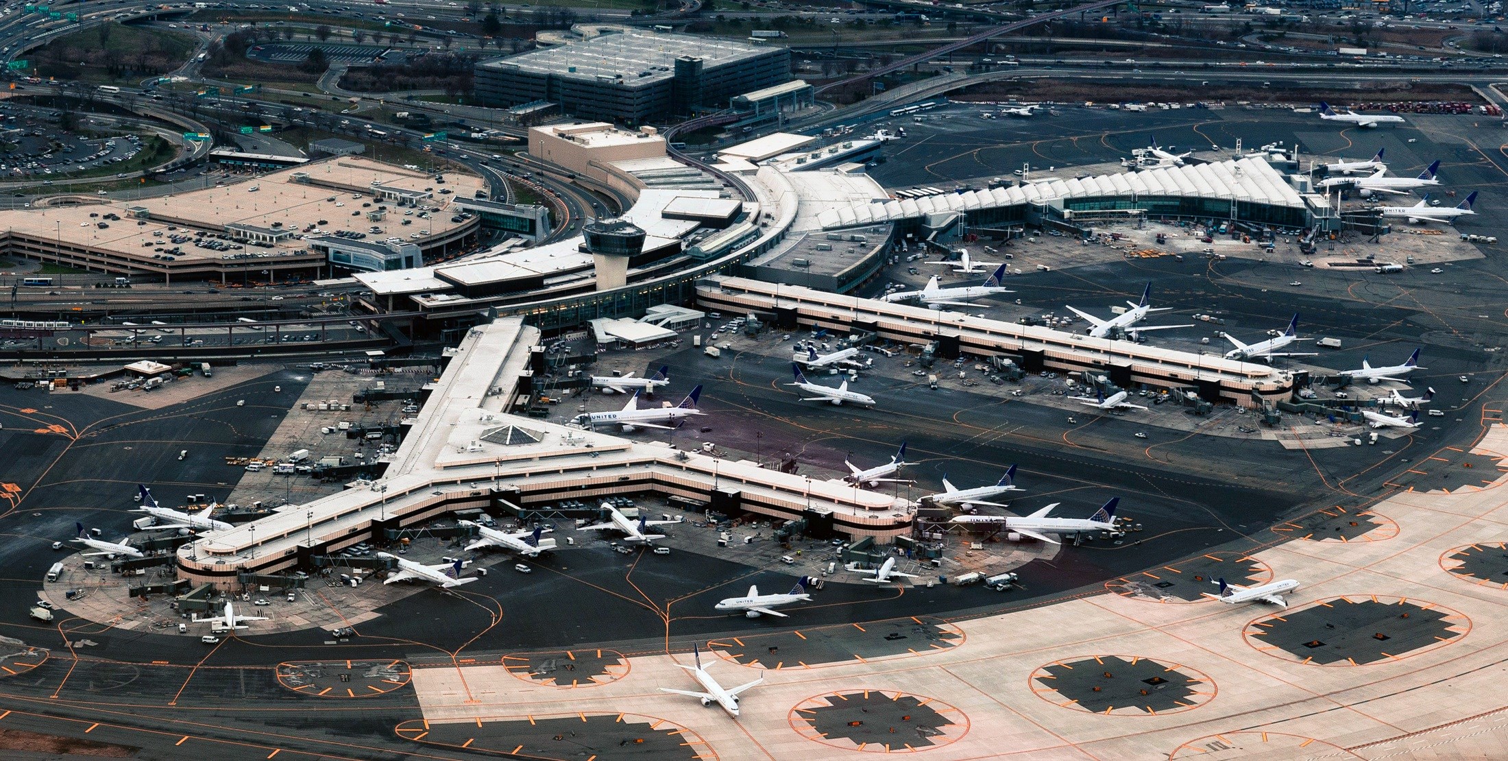 Aerial view of a busy airport with many airplanes HD Wallpaper