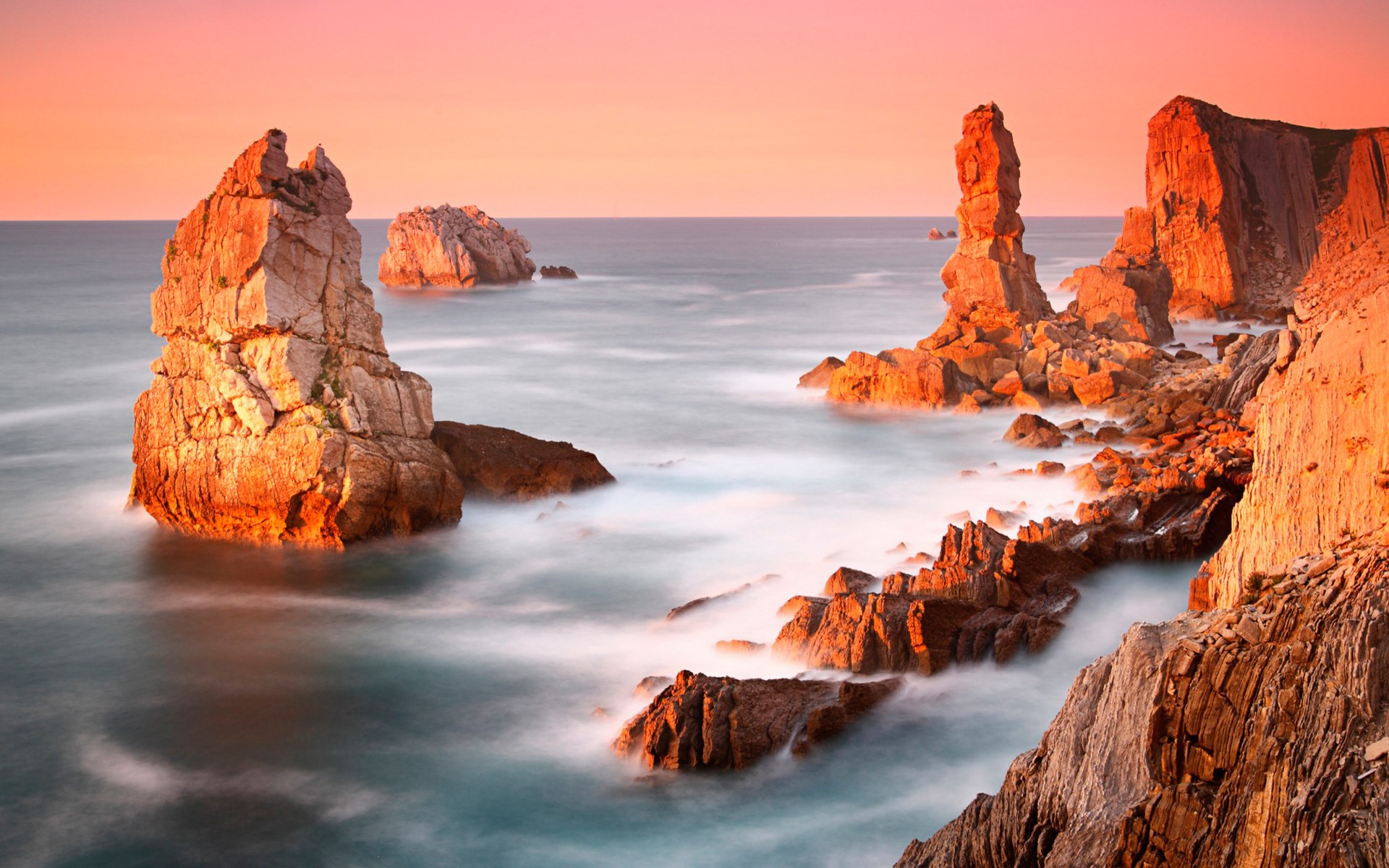 Rocky coastline with sea stacks at sunset HD Wallpaper