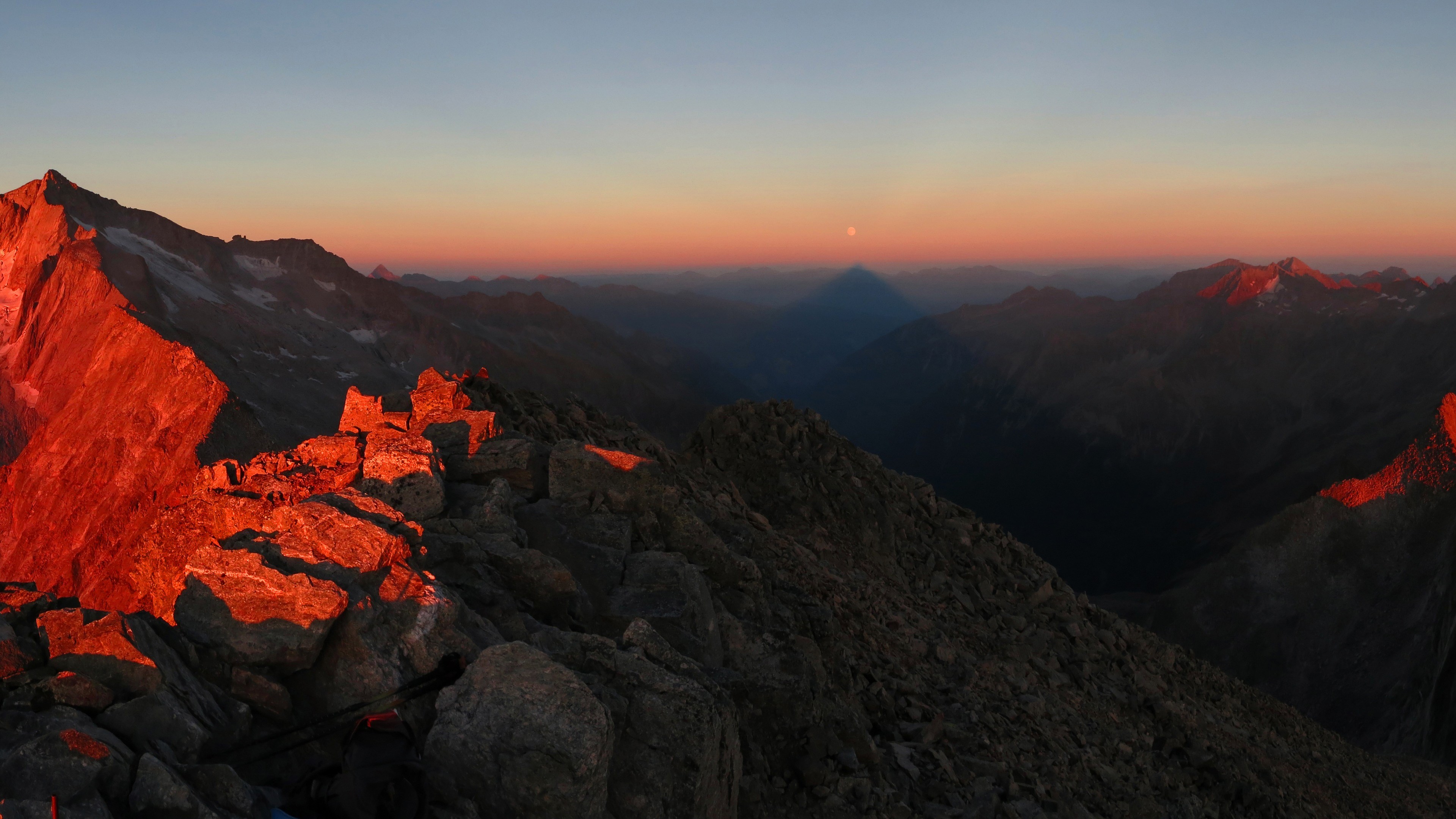 Mountain range at sunrise with shadow HD Wallpaper